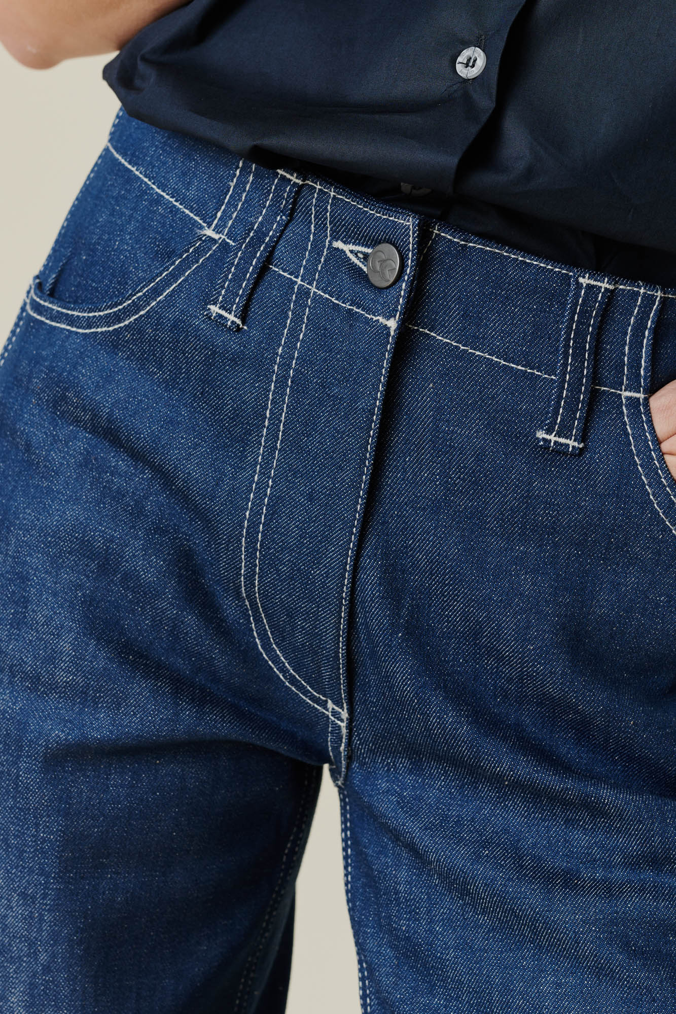 Female wearing work jean in blue. front fly, button, belt loop and pockets