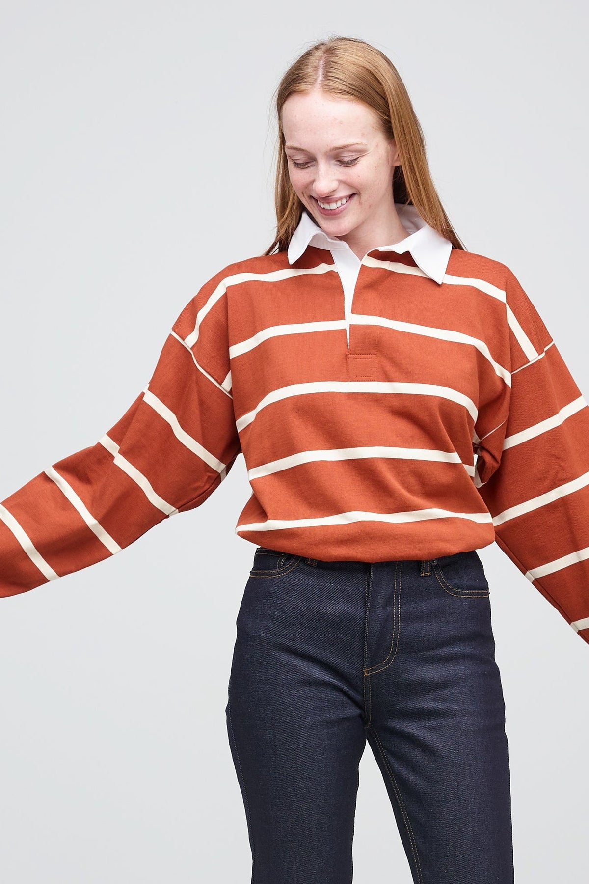 Female wearing rugby shirt in cinnamon and ecru