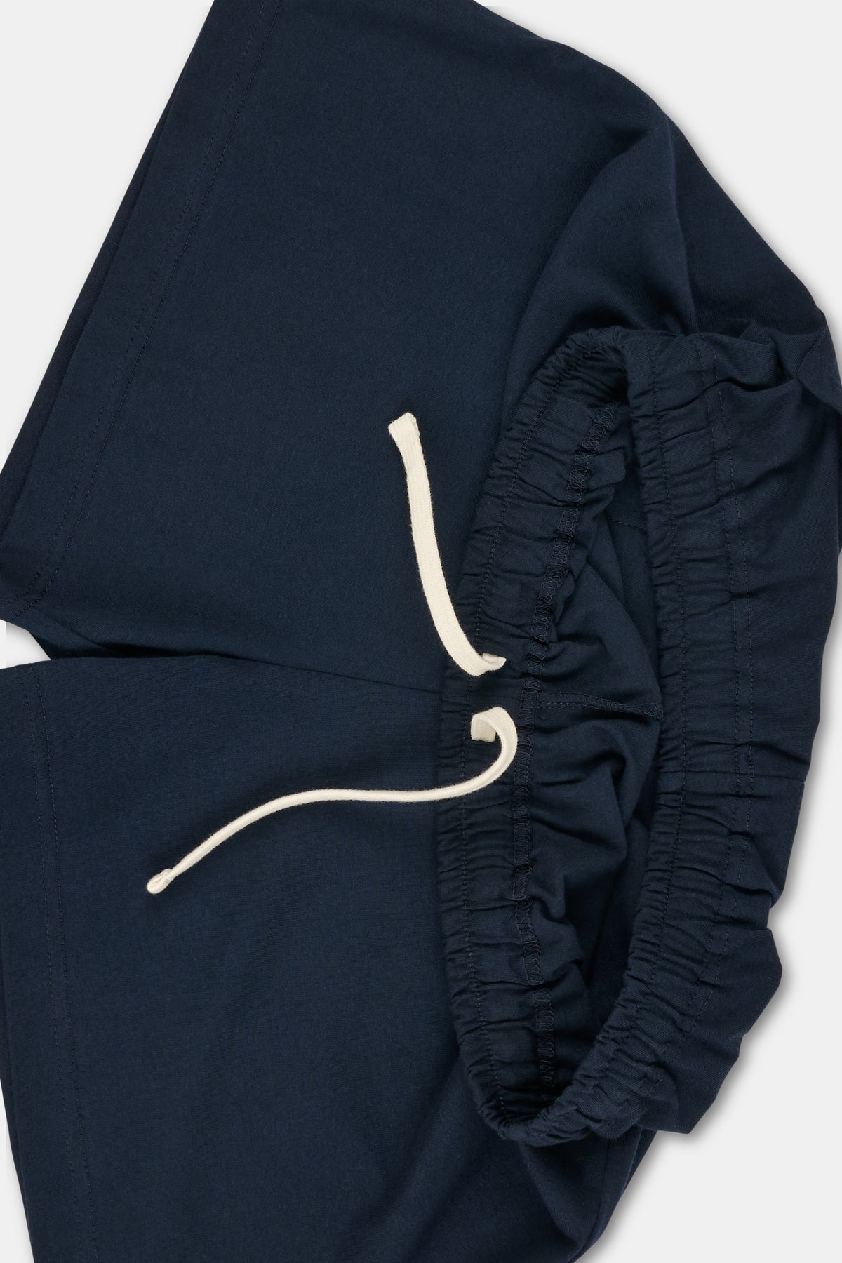 Navy jersey shorts with ecru drawcord through waist.