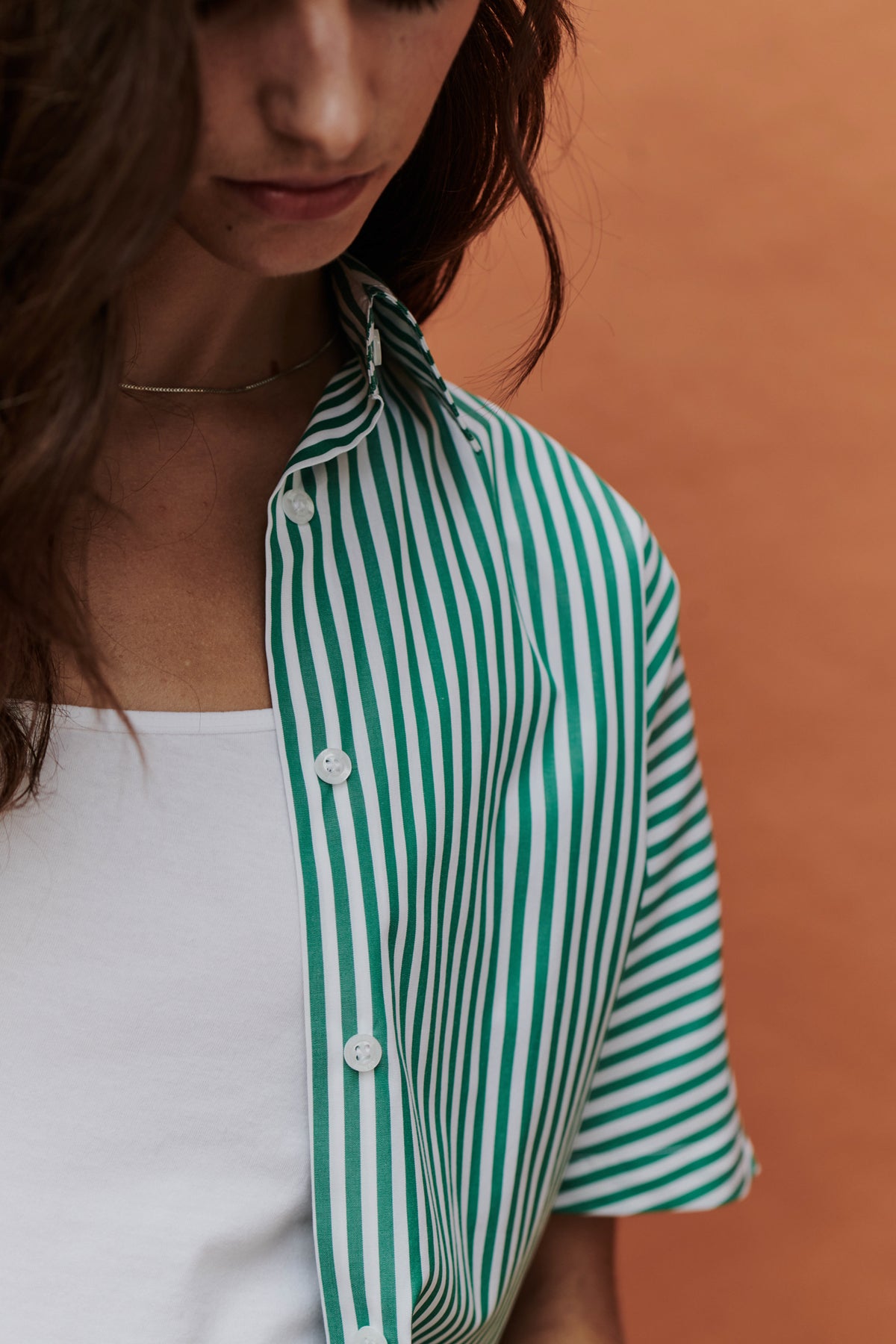 Close up of a woman wearing green and white striped shirt
