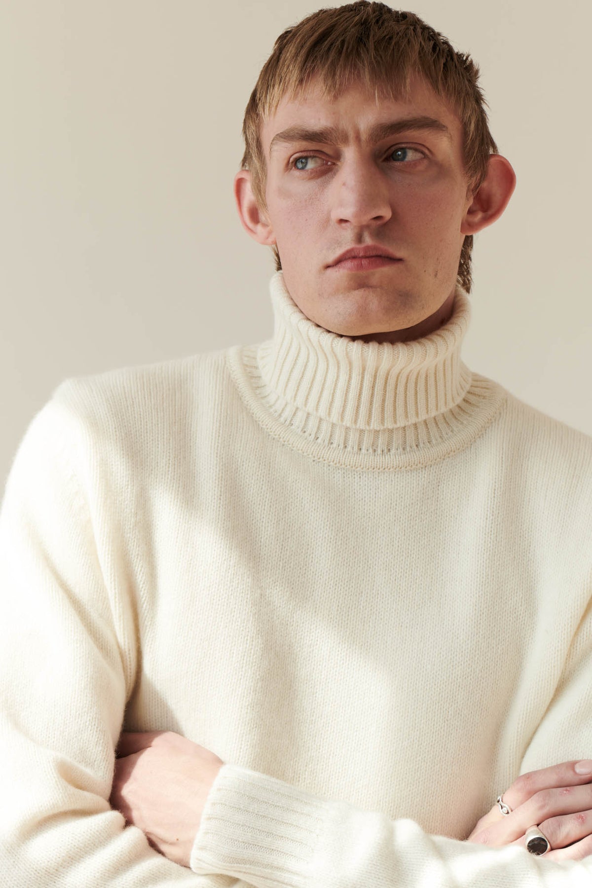 Male wearing Lambswool roll neck in Ecru