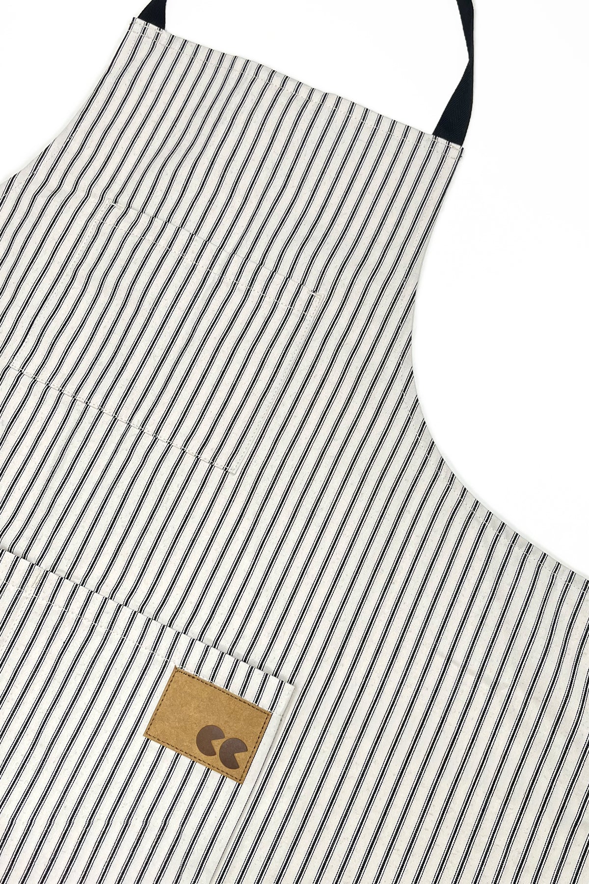 Striped apron with a brown leather patch on a white background
