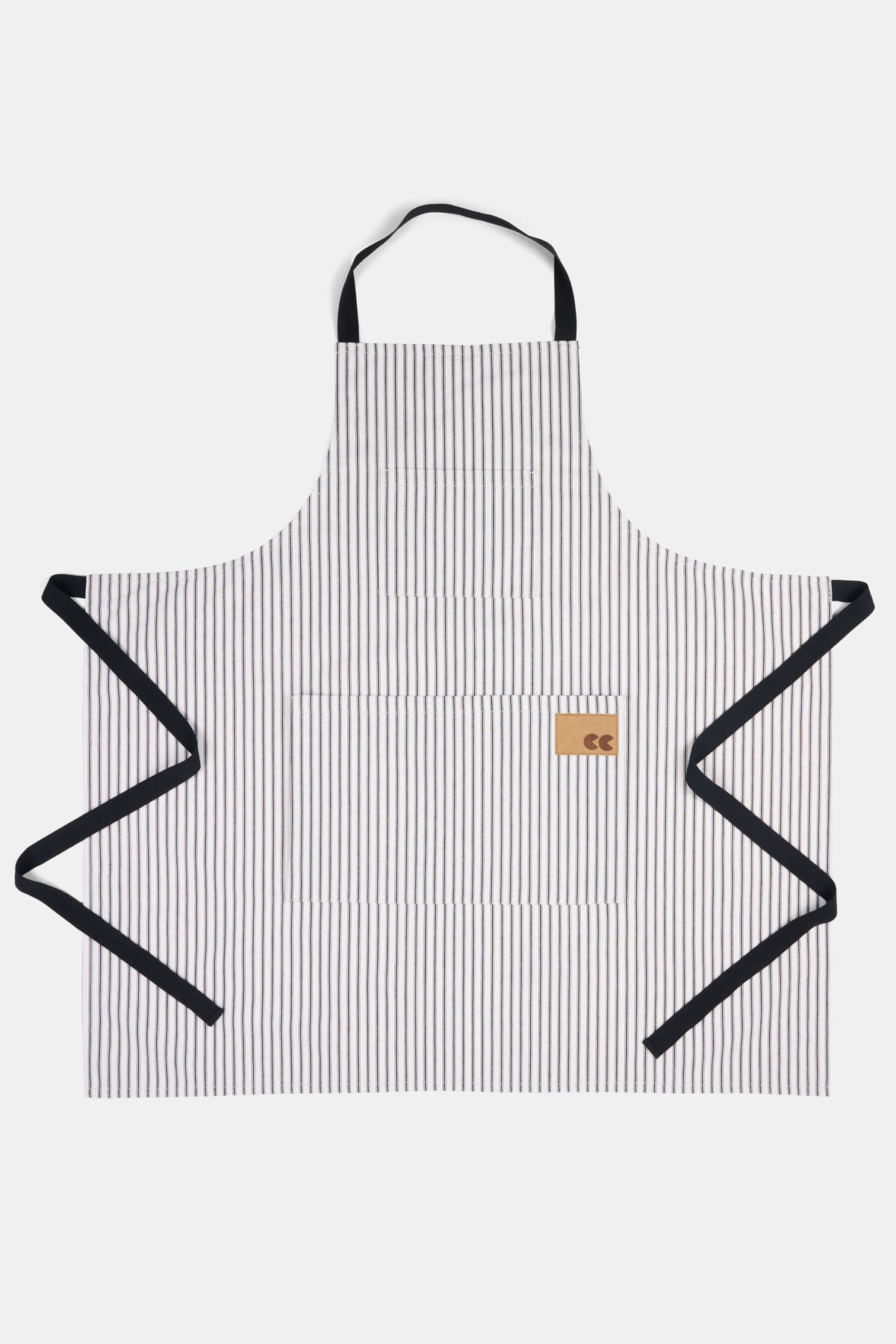 Black and white striped apron with a brown logo label on a white background.