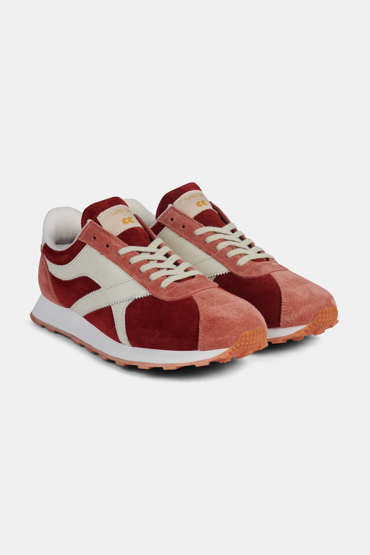 Pair of red and pink trainers on a white background.