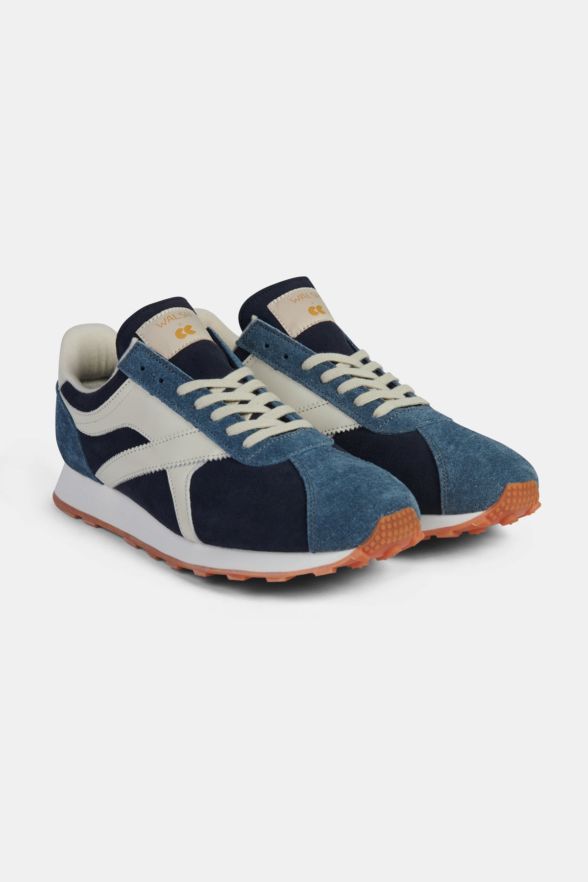 Pair of blue and white trainers on a white background.