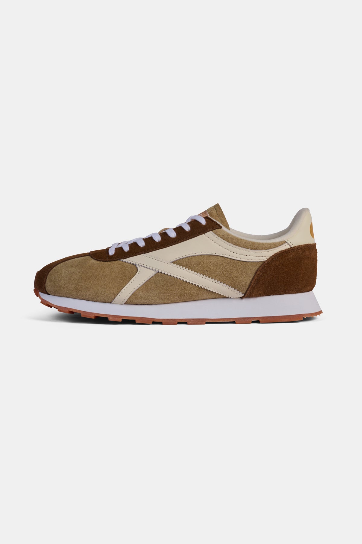 Brown and beige trainer on a white background.