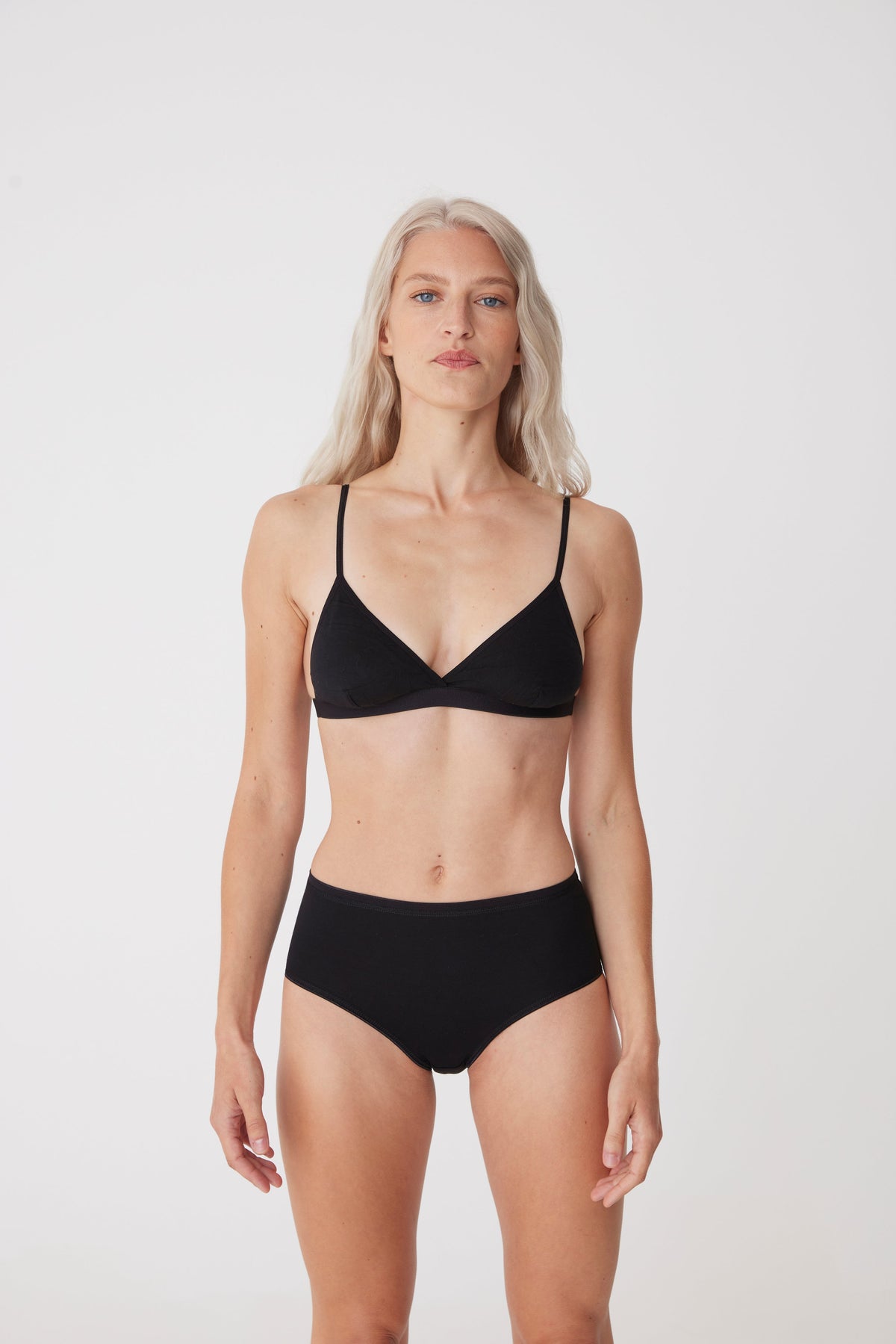 Blonde, white female wearing black bralette