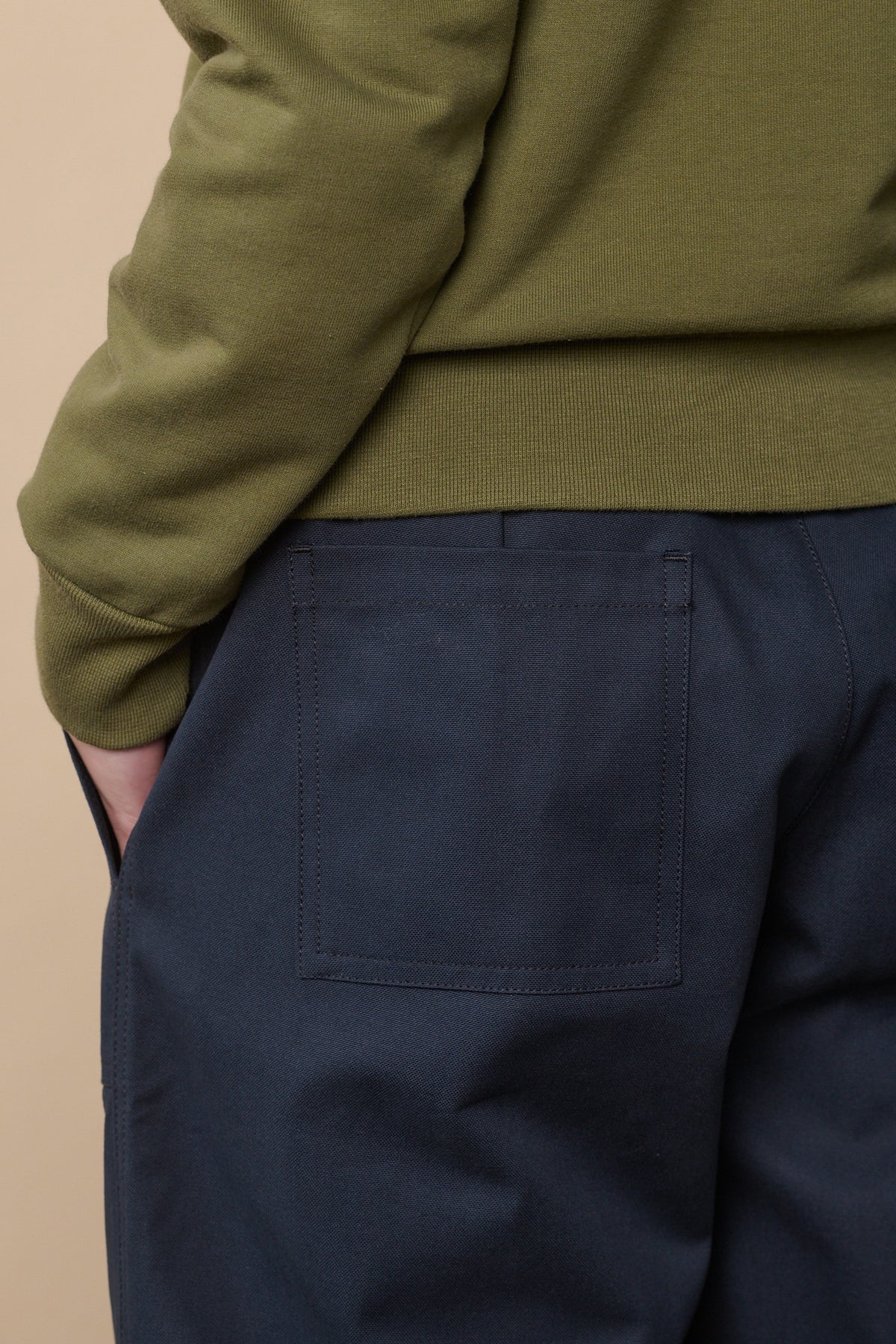 Back pocket detail of camerwoman pant in navy