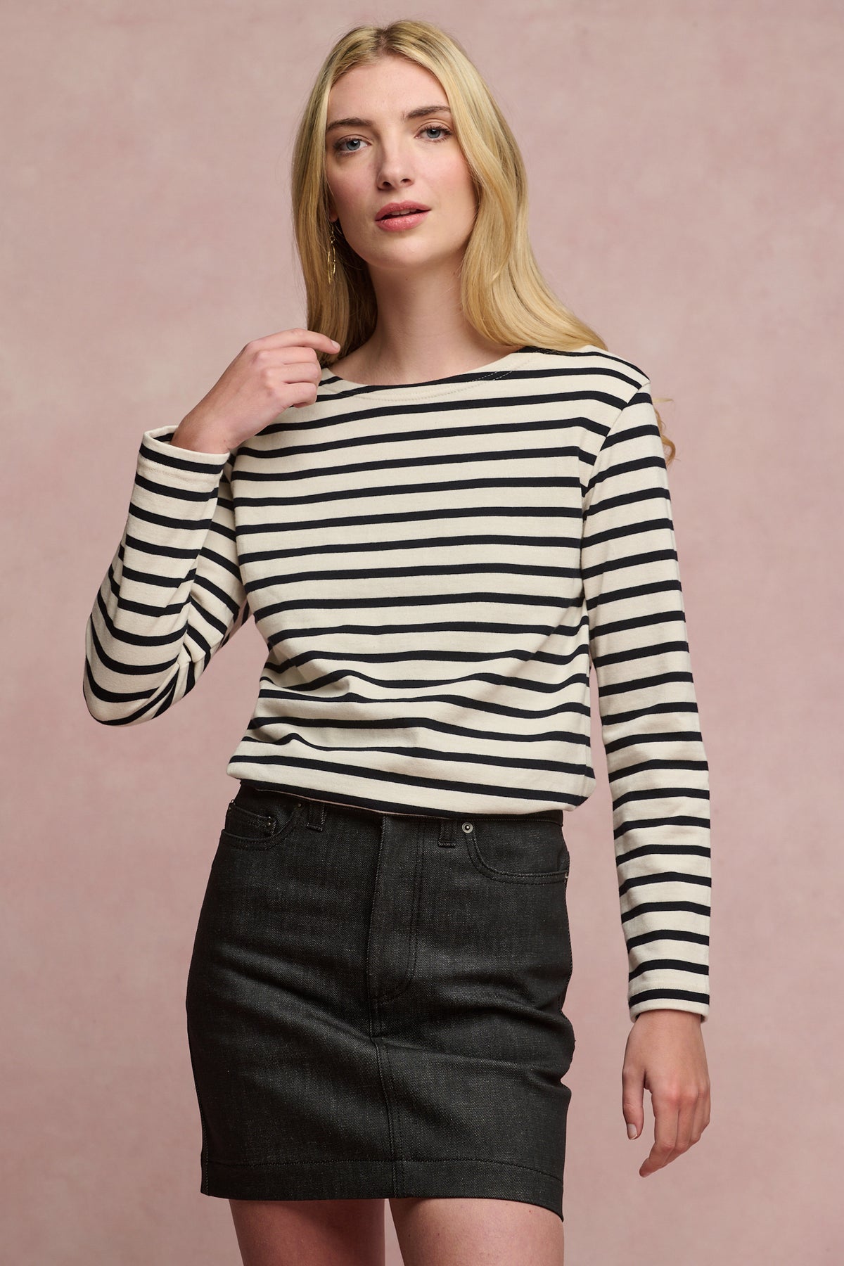 Thigh up image of blonde female wearing Charlie denim mini skirt in black paired with Breton in white/black