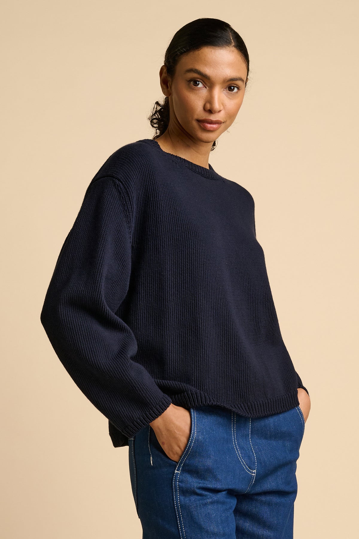Woman wearing navy sweater.