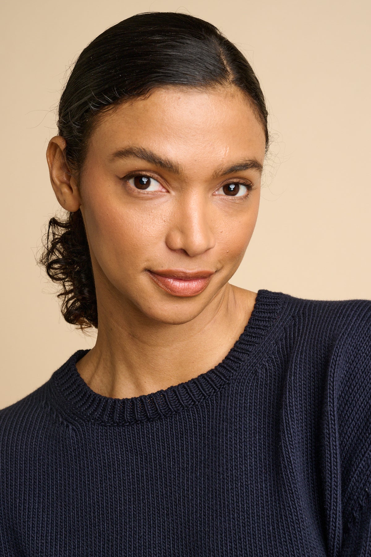Woman wearing navy sweater.