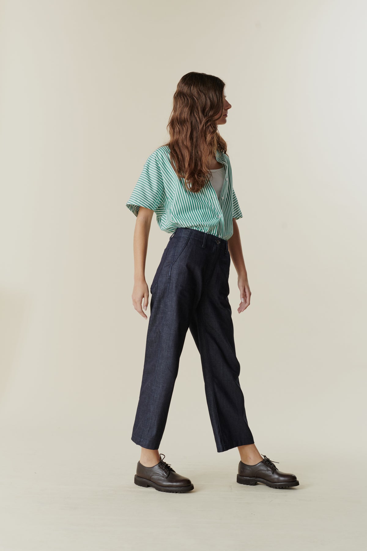 Side view of female wearing cropped work trousers in denim