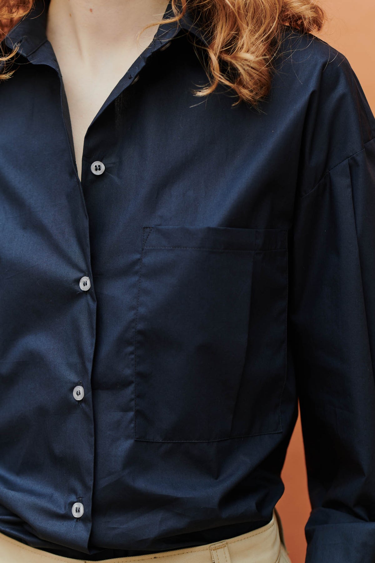 Close-up detail shot of the pocket on the esme long sleeve shirt in navy