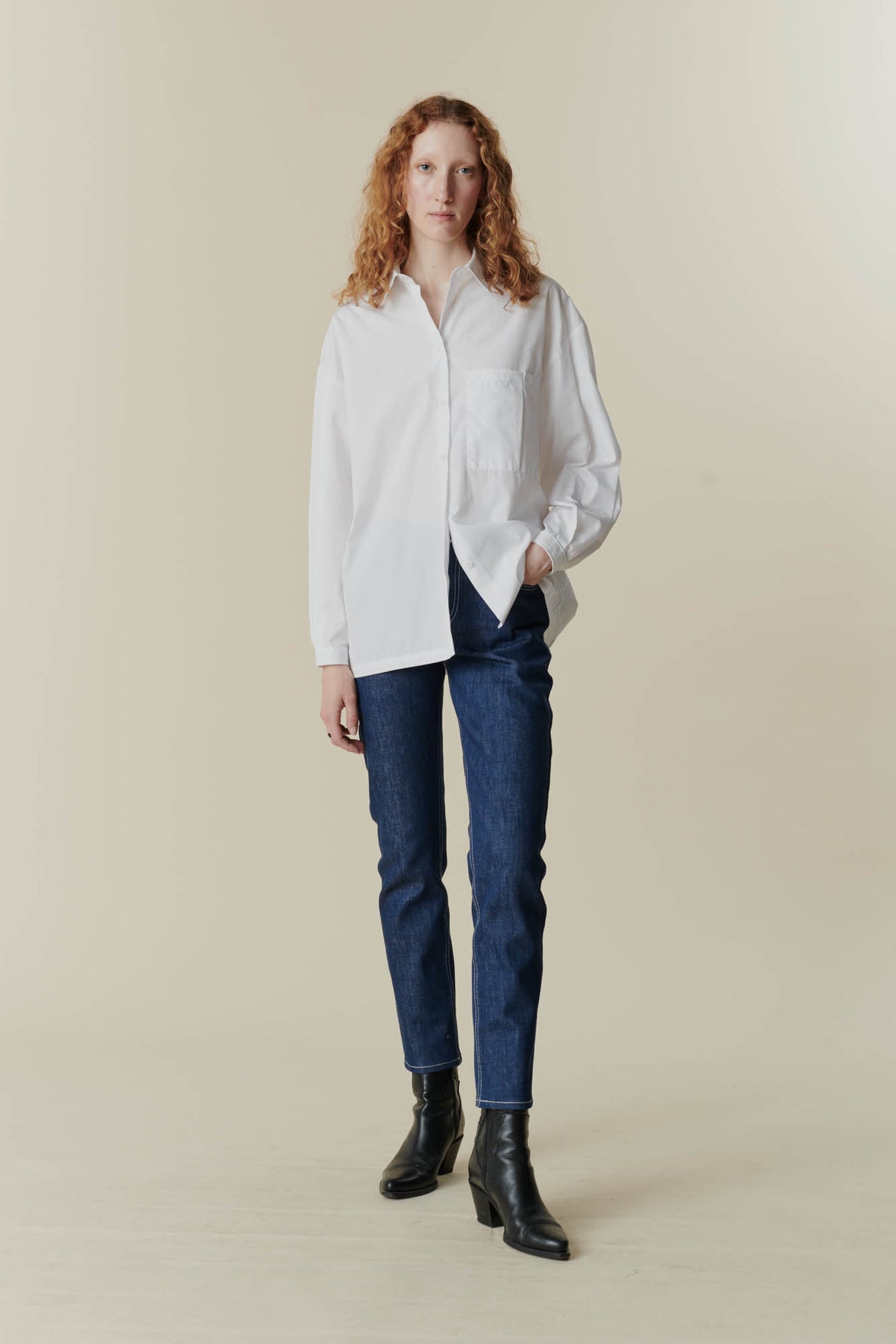 female wearing white esme shirt and some high rise jeans from community clothing