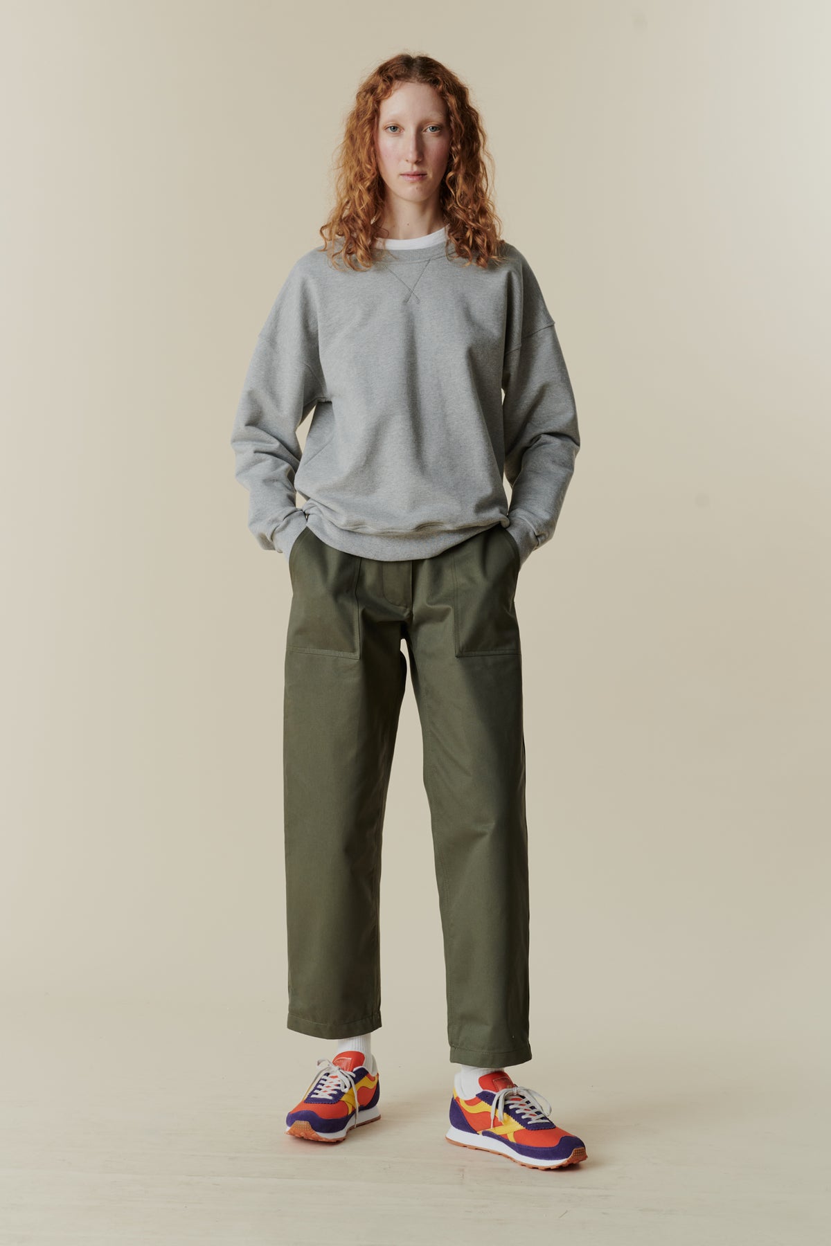 Full body front of female wearing heritage sweatshirt in navy