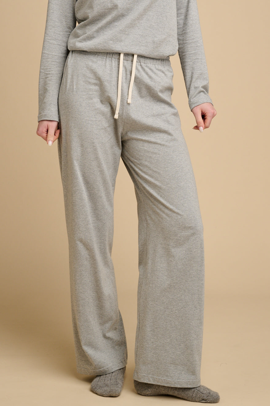 Woman waist down wearing grey marl pyjama bottoms