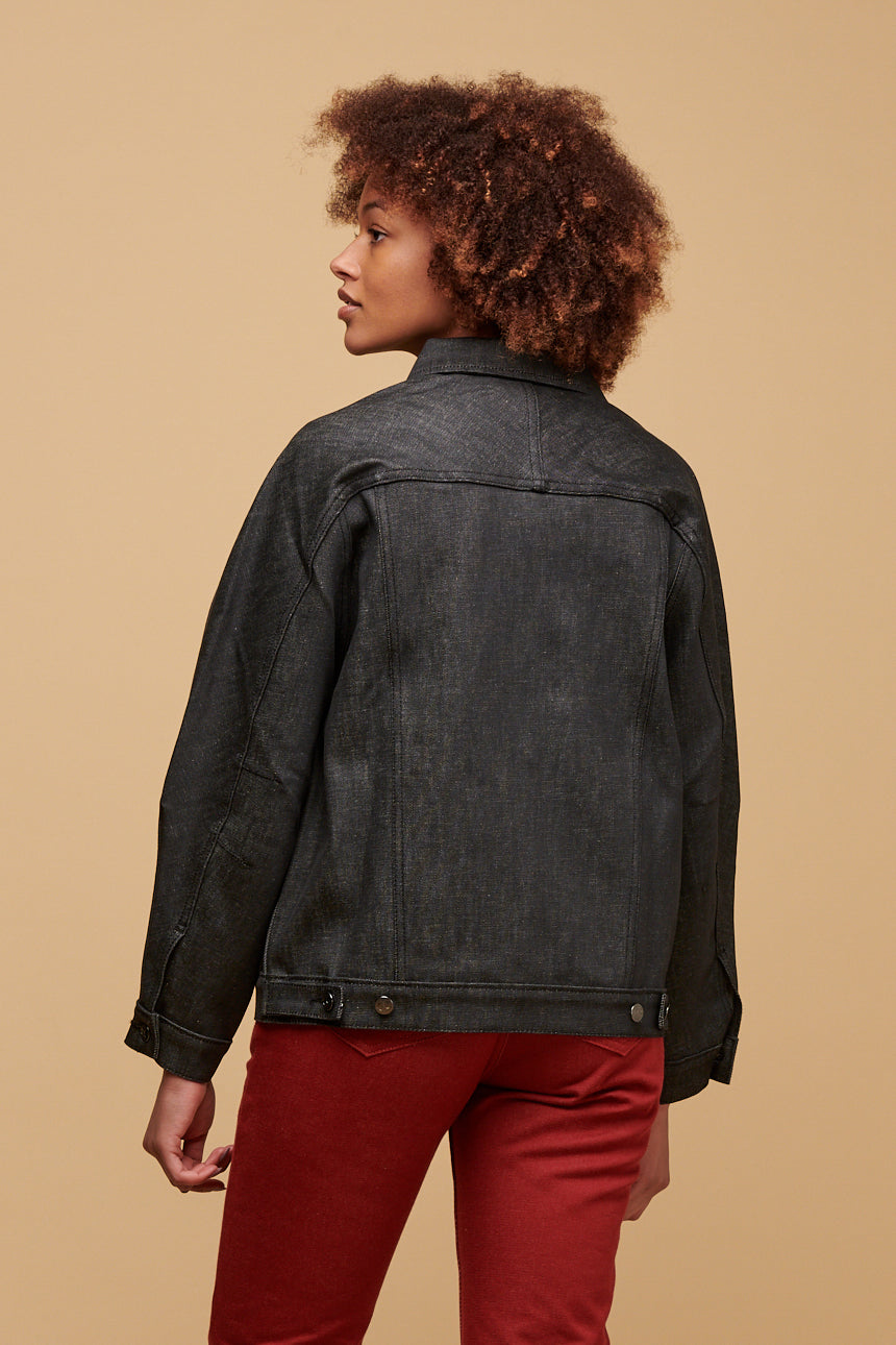 Thigh up of the back of black female looking to the side wearing Jodie jacket in black paired with Gloria jean in burgundy
