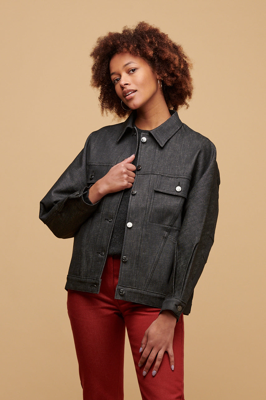 Thigh up of black female wearing Jodie jacket in black unbuttoned over lambswool crew neck in charcoal paired with Gloria jean in burgundy