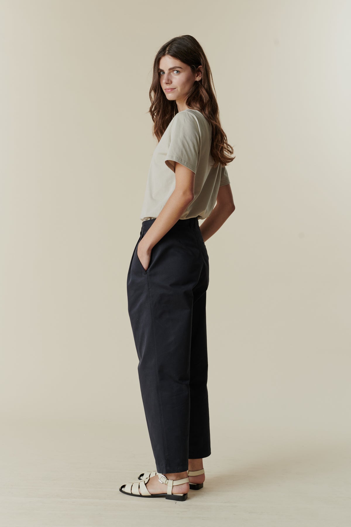 Female wearing pleated jeans in navy