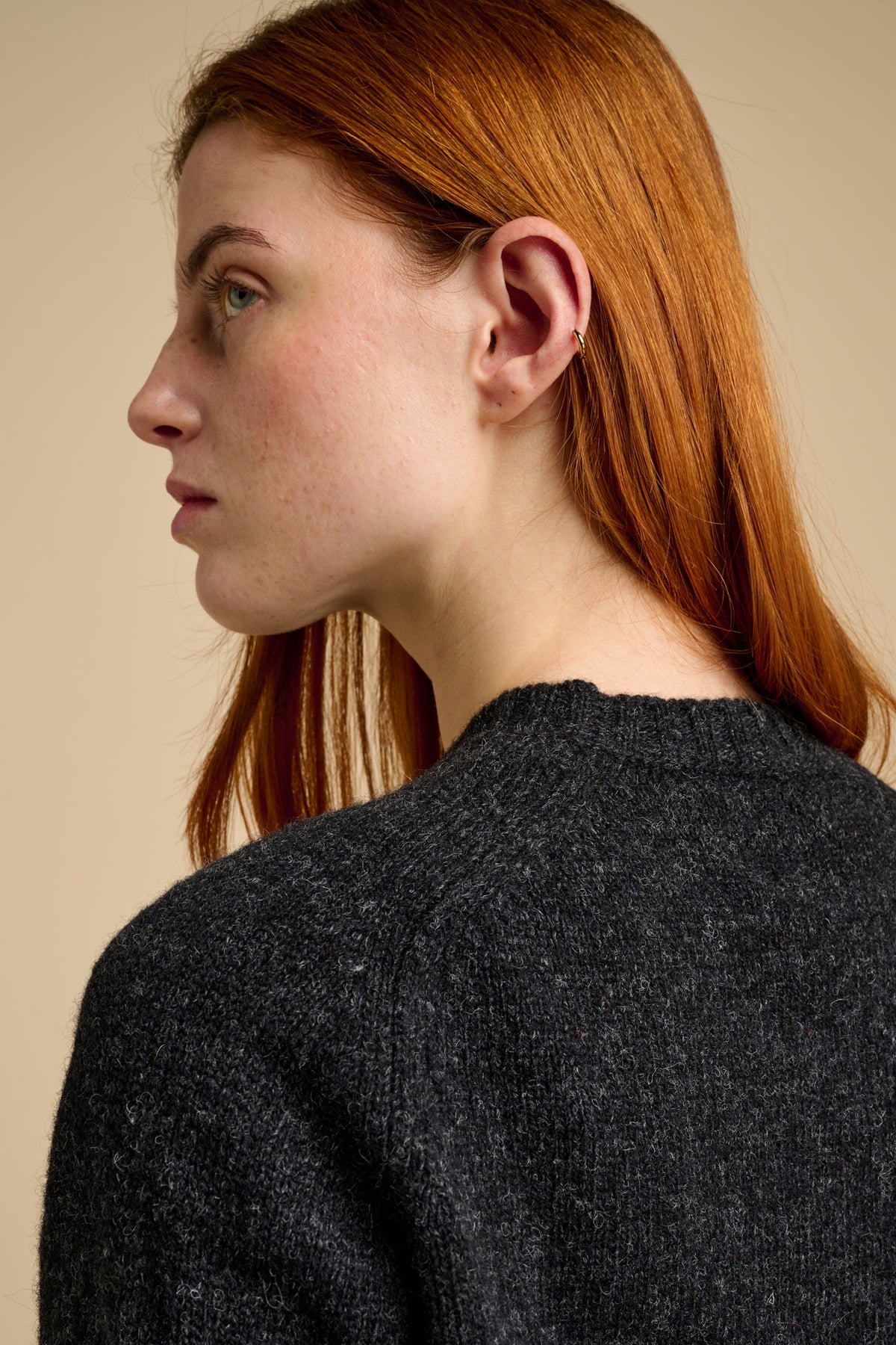 Woman wearing charcoal grey knit jumper