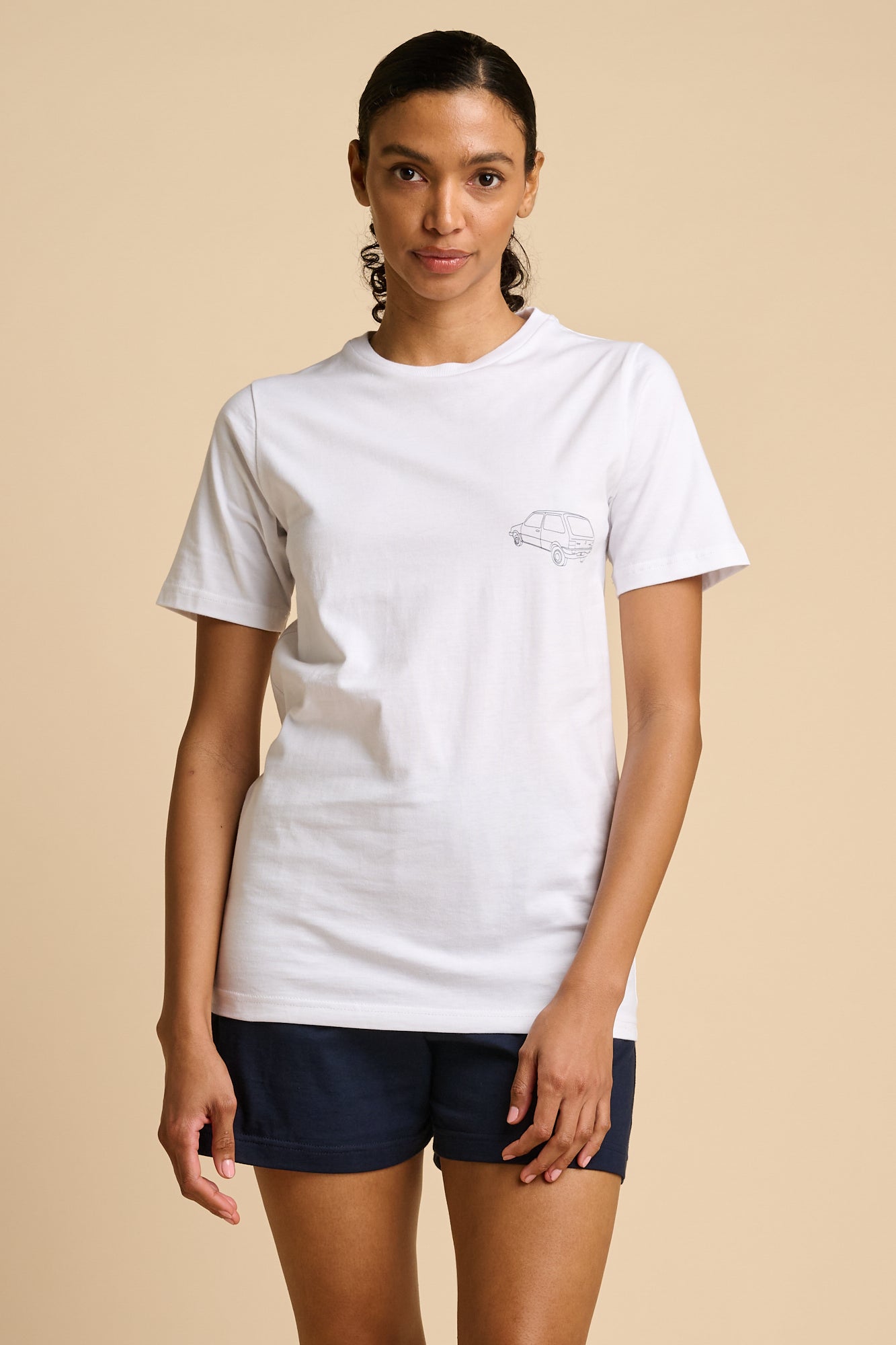 Woman wearing a white t-shirt with a small graphic print.