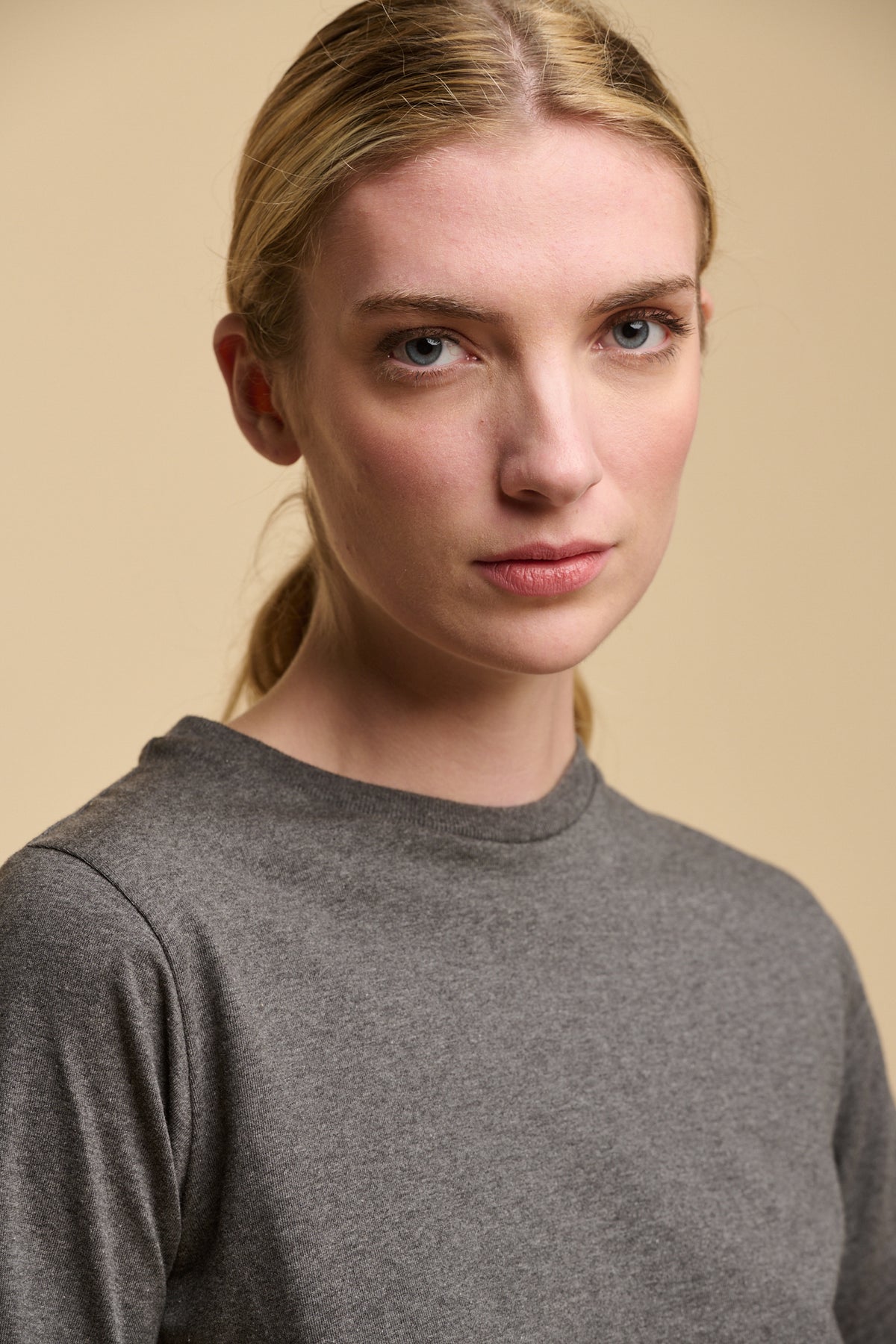 Head shot of female wearing crewe neck short sleeve t shirt in charcoal