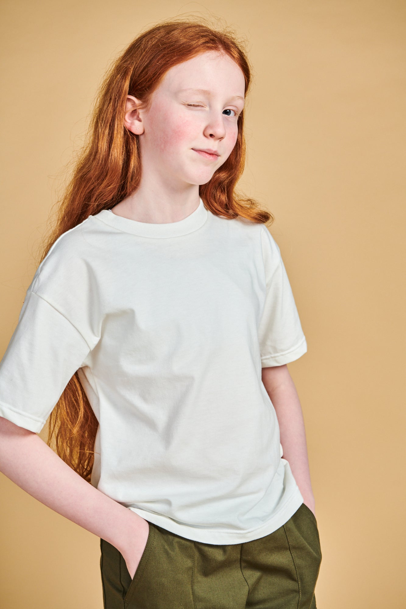 Young girl wearing plastic free short sleeve t shirt  in bone 