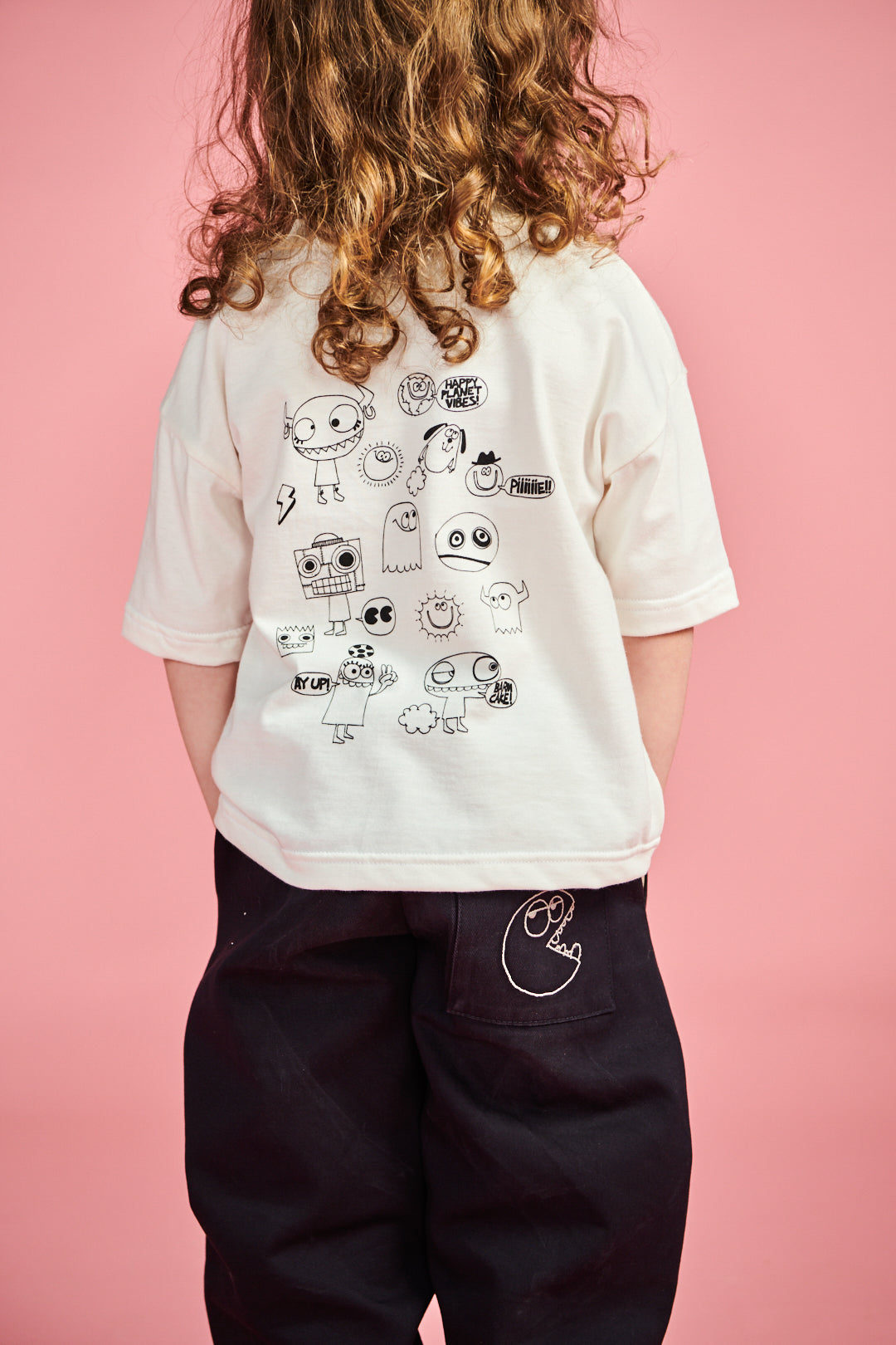 Young boy wearing short sleeve t shirt plastic free in bone with ghost print on chest