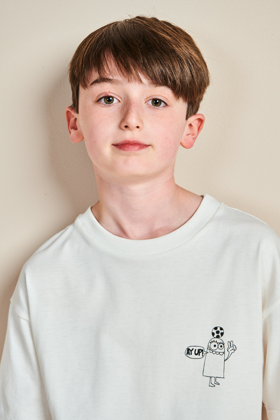 Girl wearing short sleeve t shirt with 'aye up!' pri