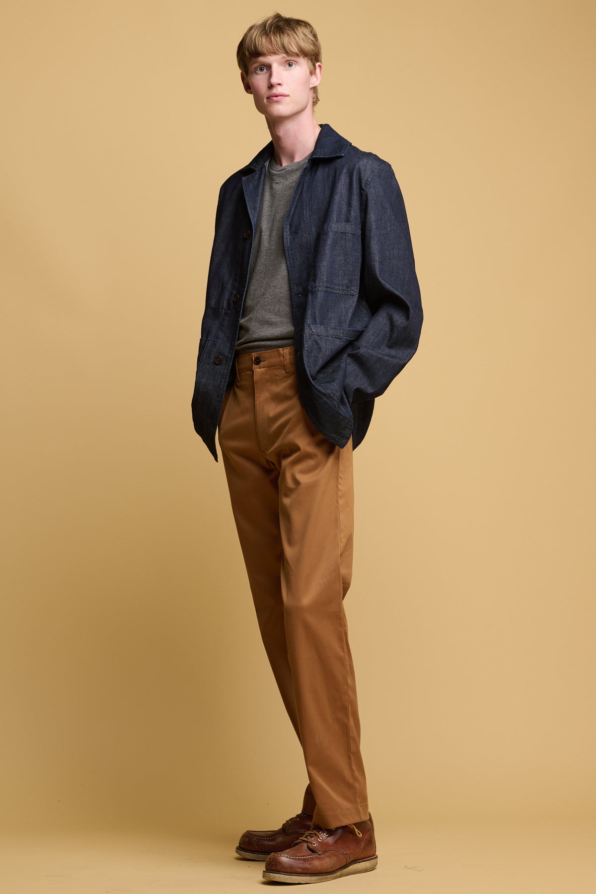 male wearing chore jacket in indigo denim paired with slim stretch chino in indigo denim