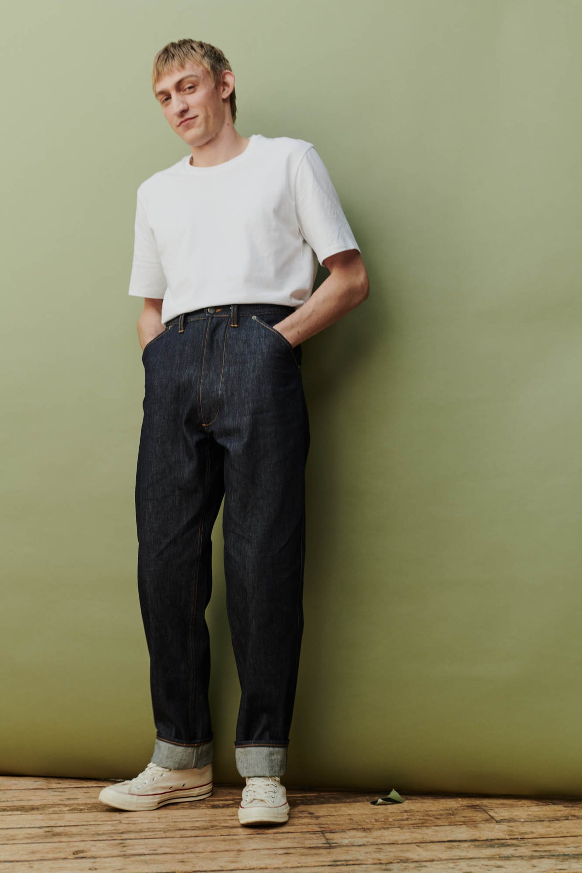 Full body front shot of male in chore jean indigo