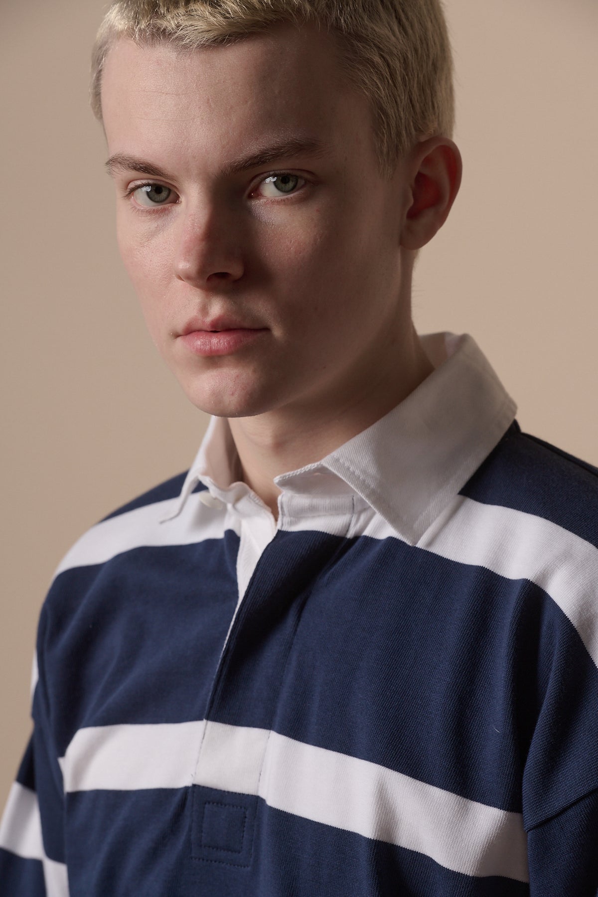 Portrait of white male wearing rugby shirt in navy white