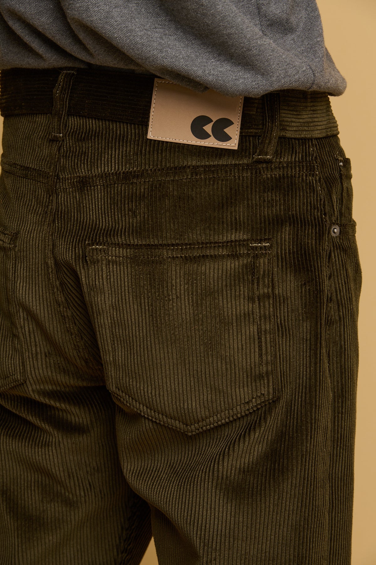 Close up of the back of Community Clothing men's five pocket cord trousers in dark olive 
