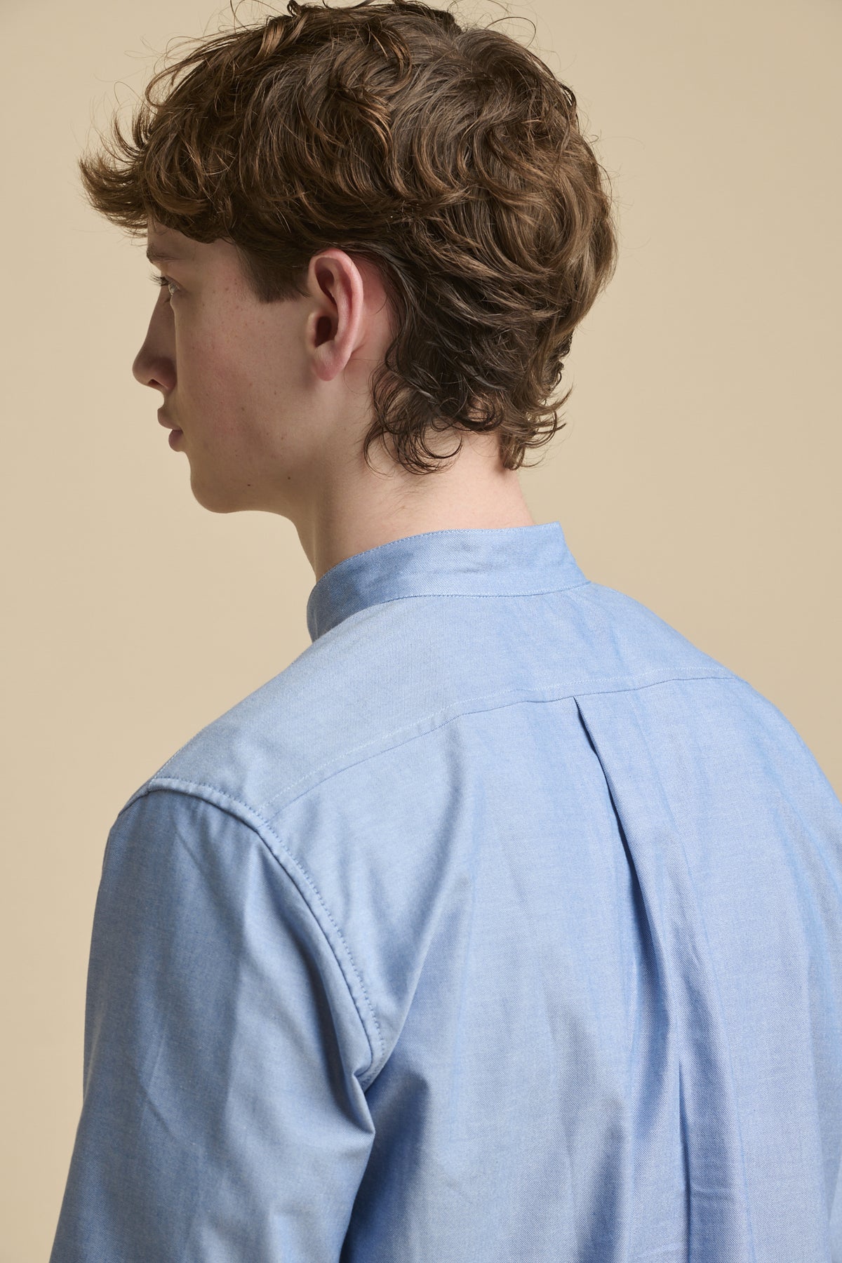 Detail of the shoulders of male wearing light blue George Lightweight Collarless Overshirt
