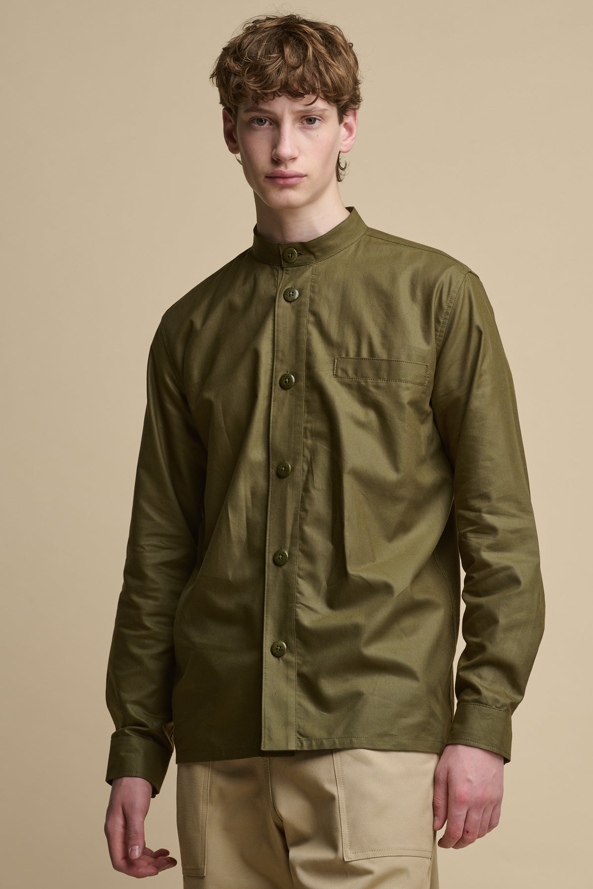 Male wearing buttoned up men's George Lightweight Collarless Overshirt in Olive