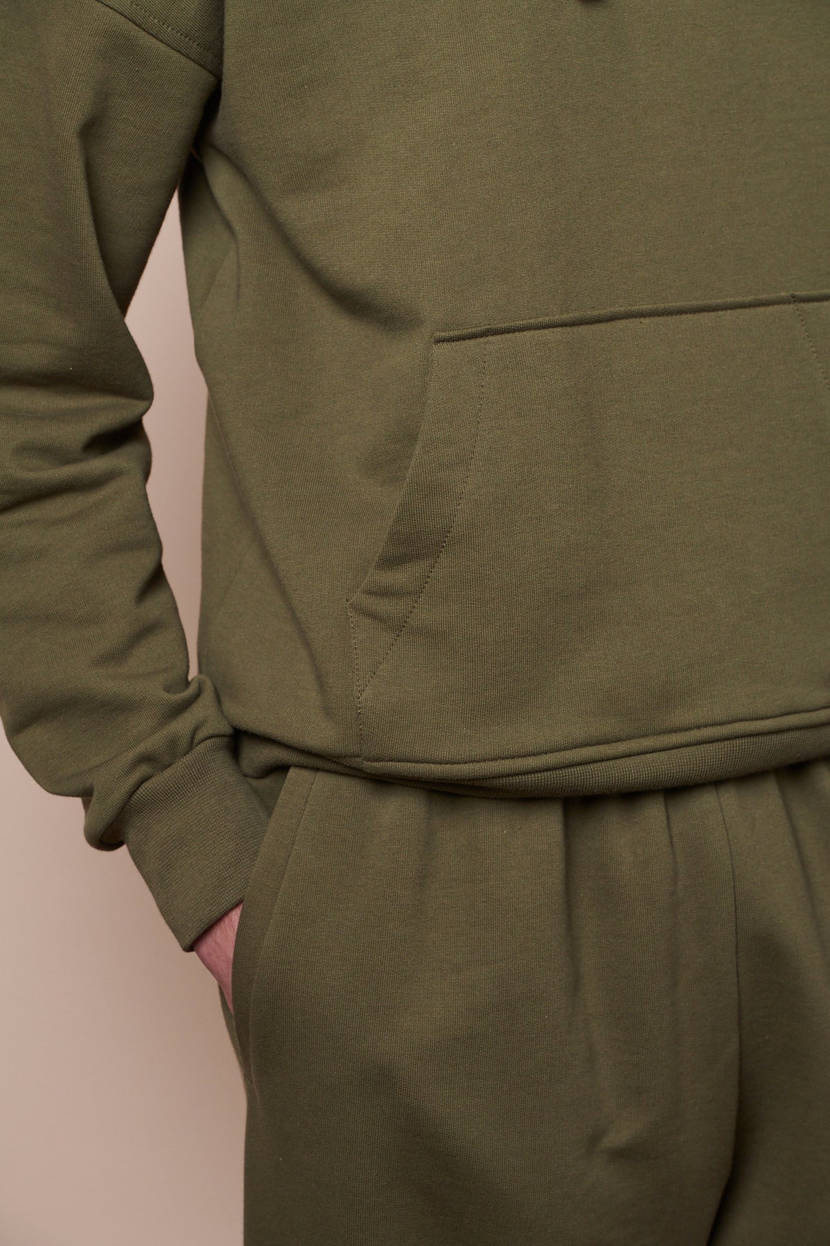 Close up of hooded sweatshirt front pocket and ribbed cuff with matching sweatpants