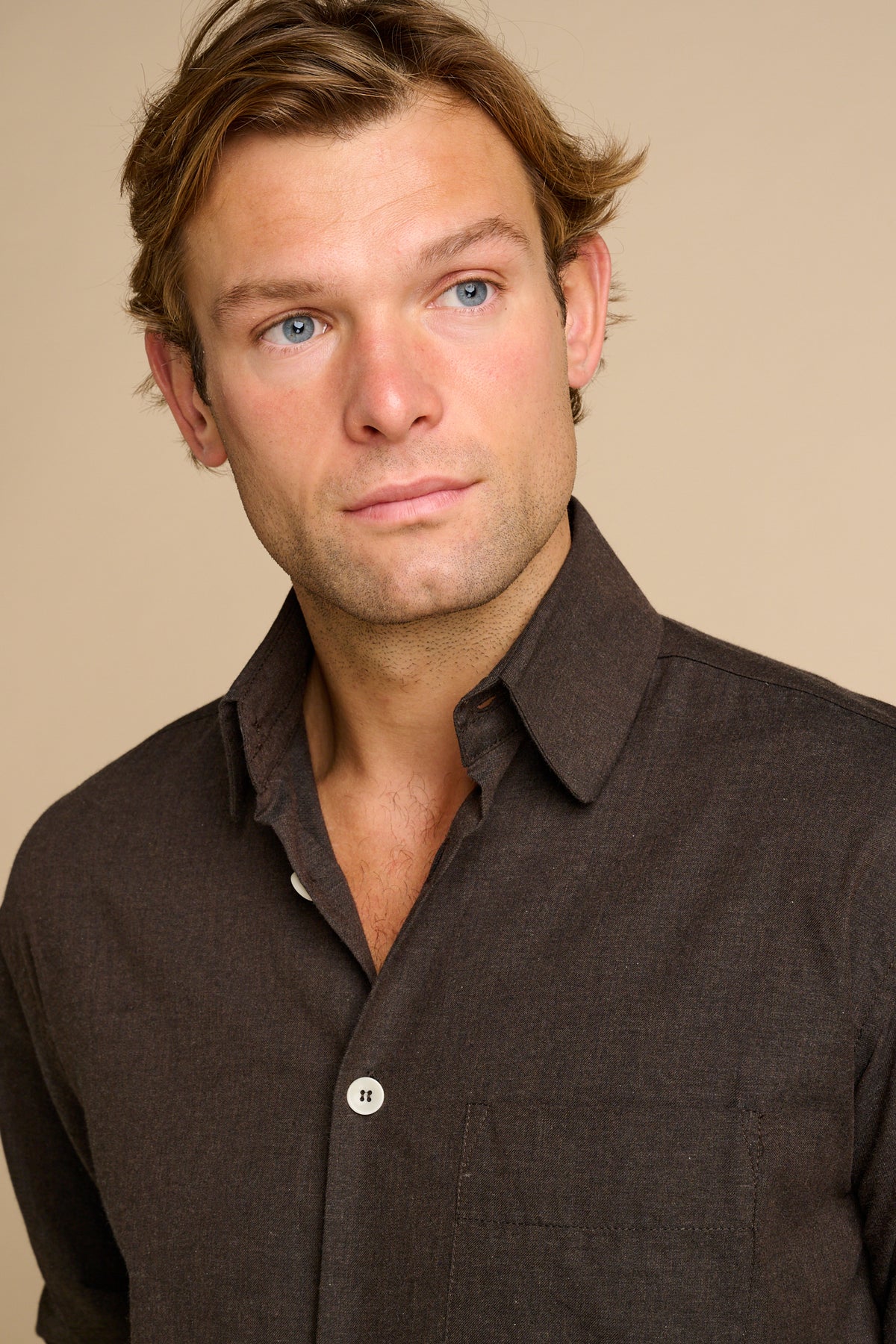 Portrait of male wearing brown shirt.