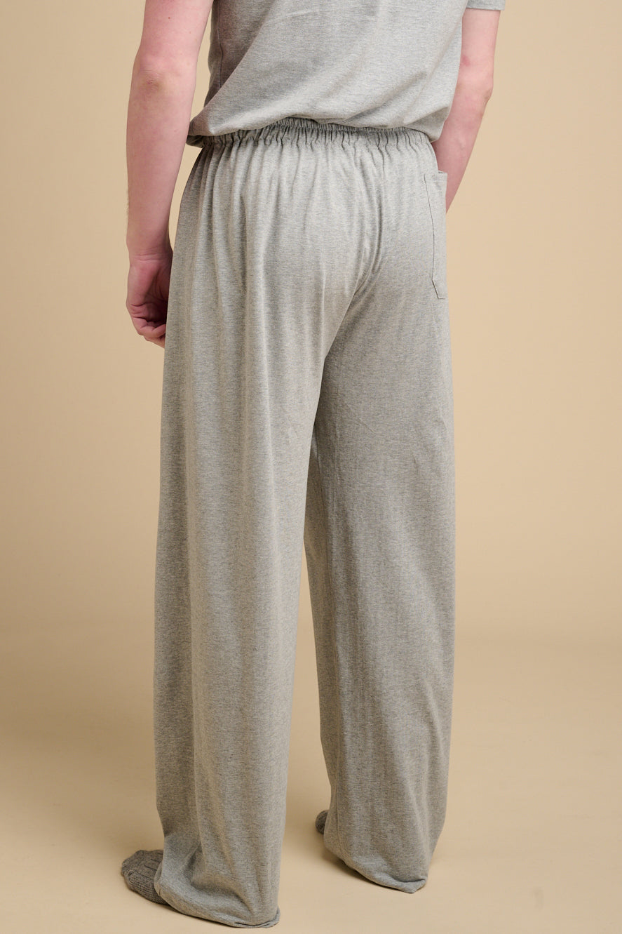 The back of male waist down wearing grey marl pyjama bottoms.