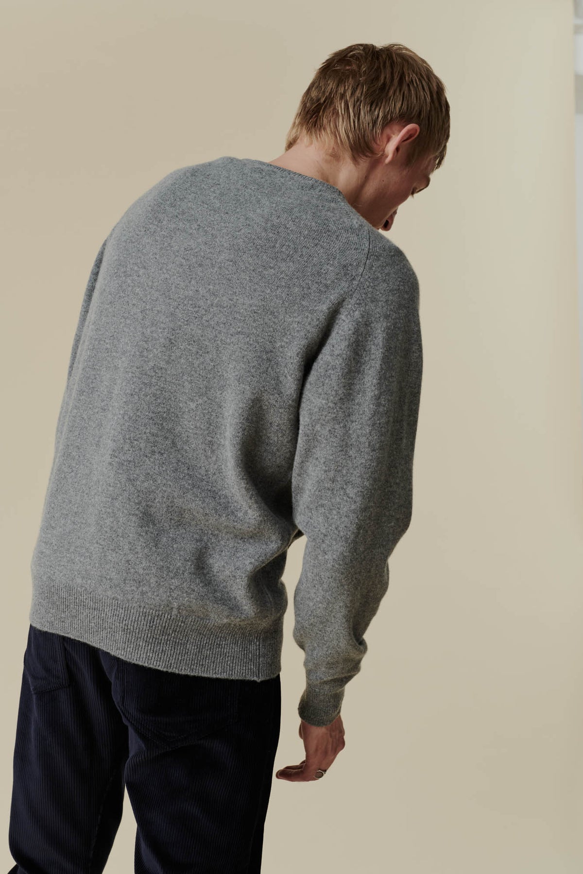 Back of white male wearing grey lambswool crew neck