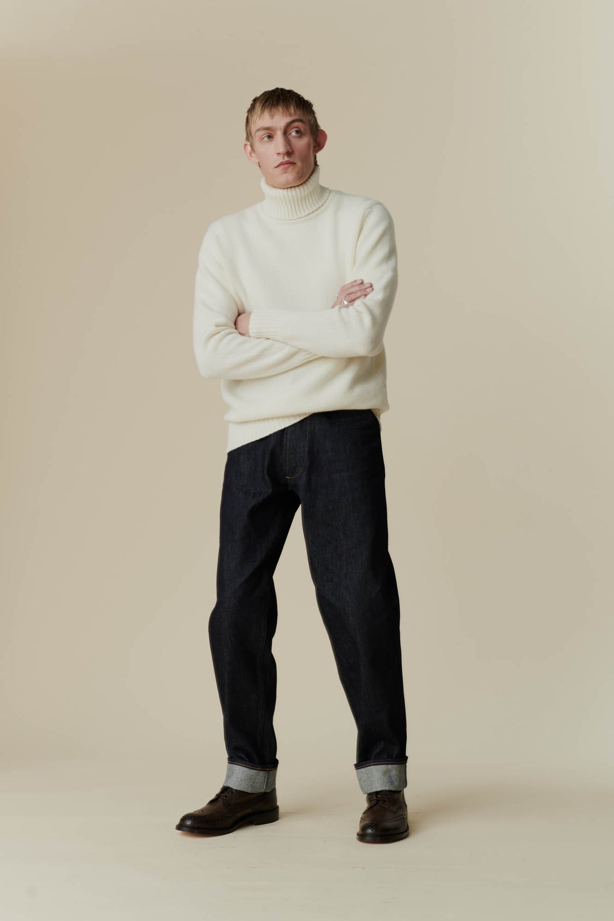 Male wearing Lambswool roll neck in Ecru
