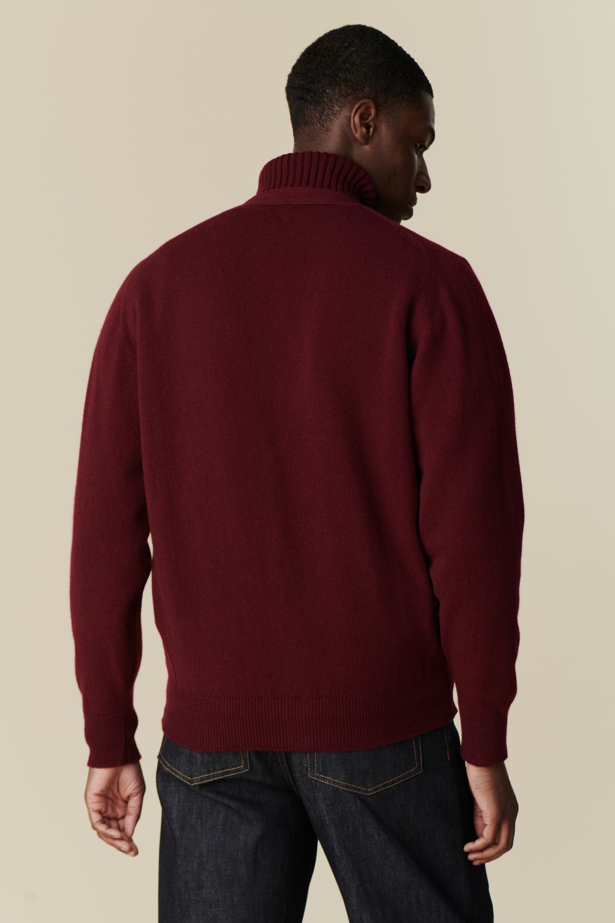 Image of back of male wearing lambswool cardigan in burgundy