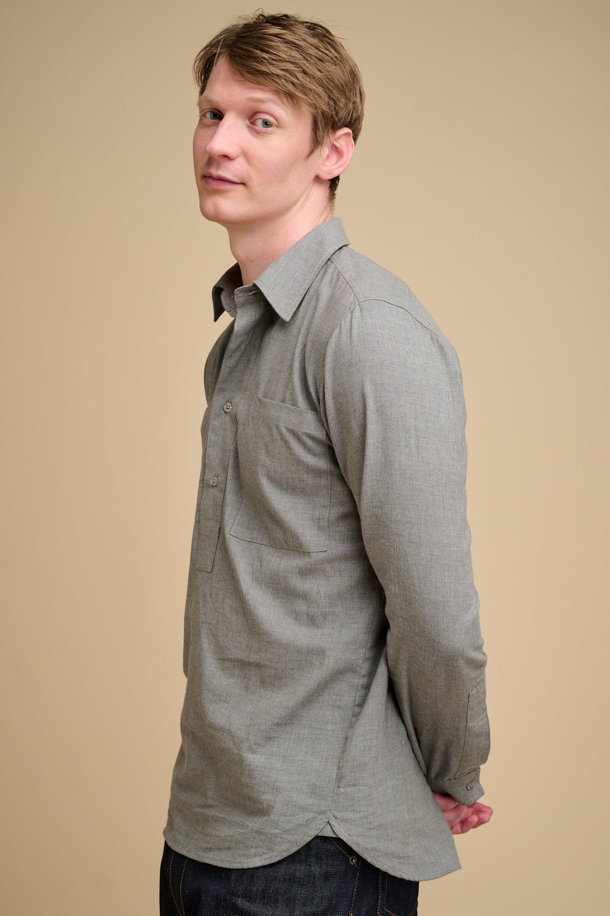 Man wearing grey half placket shirt.