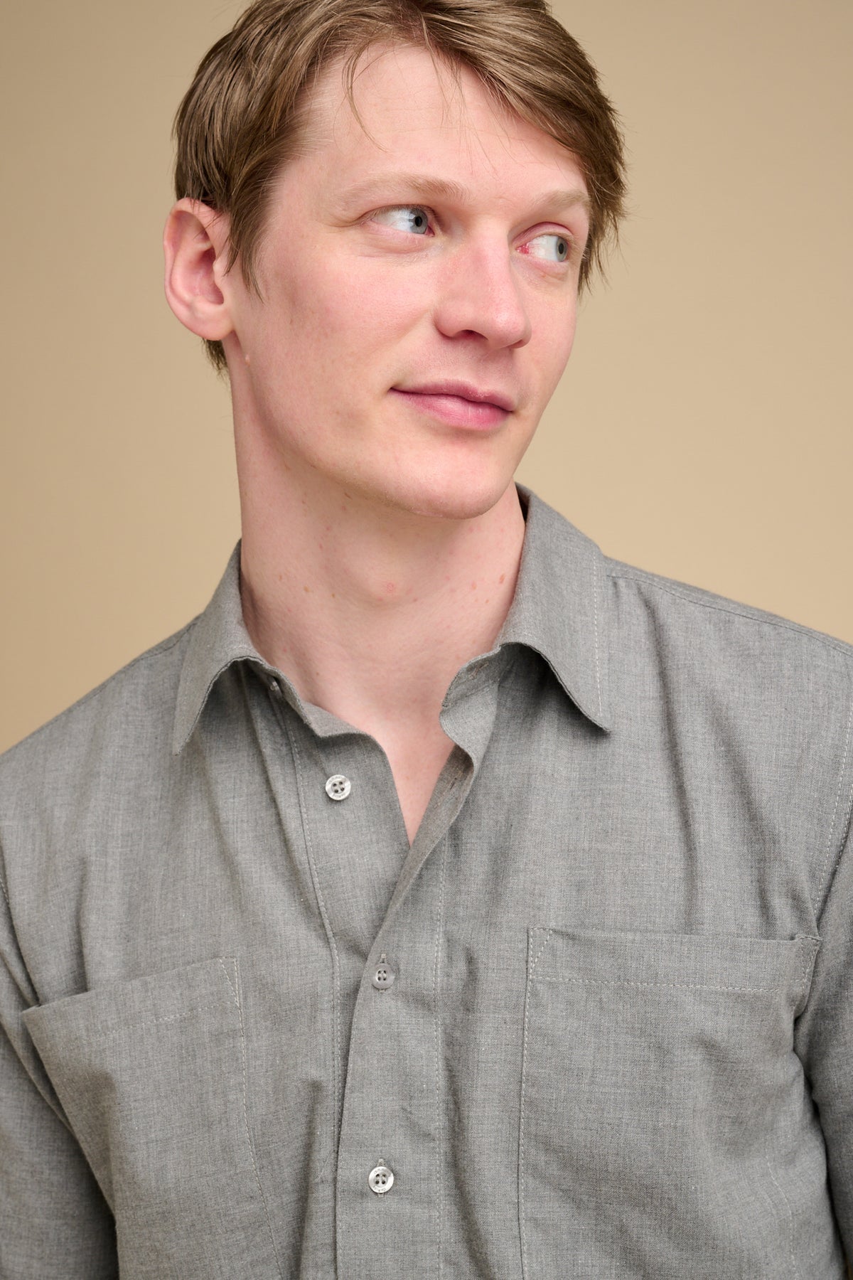 Man wearing grey half placket shirt.