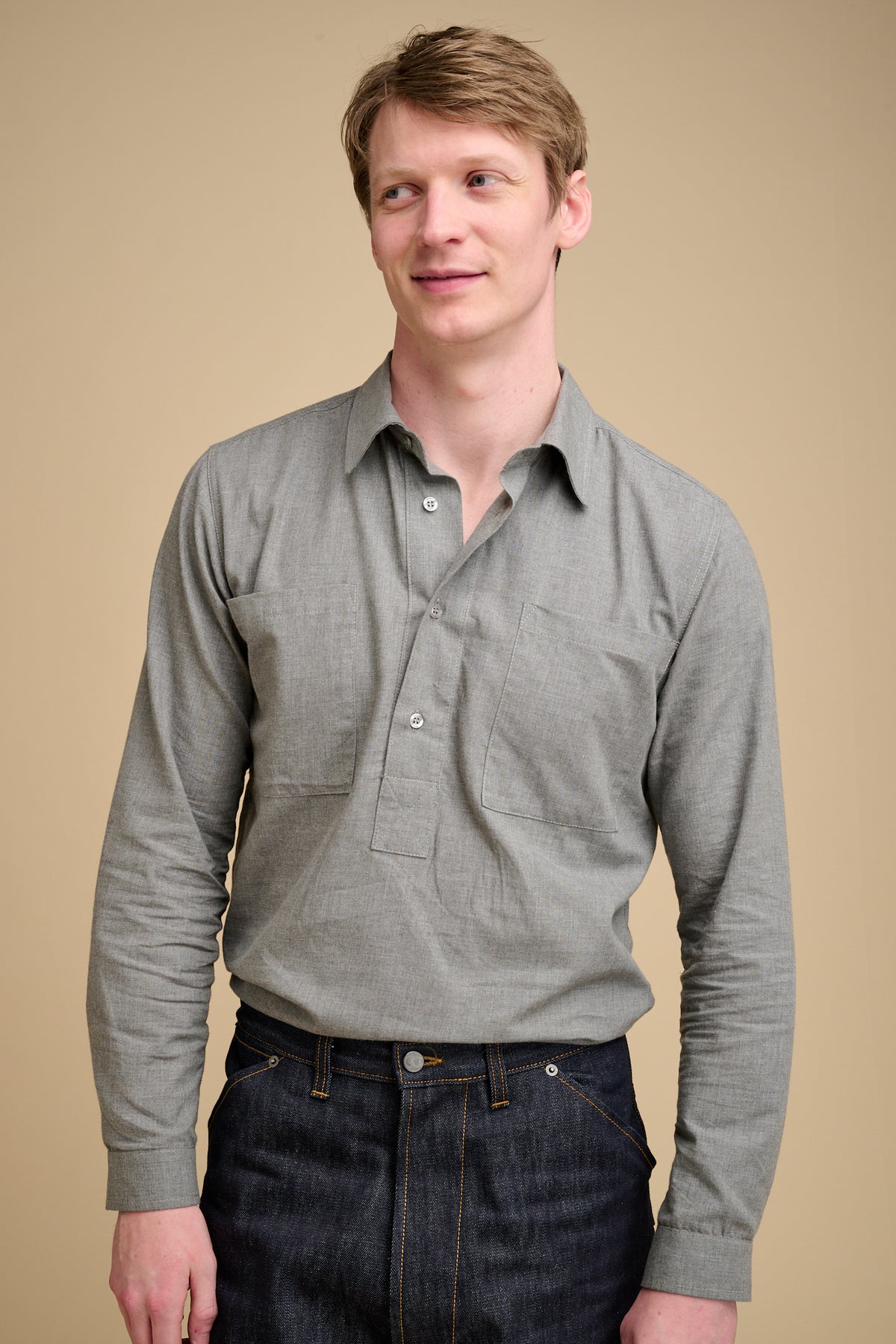Man wearing grey half placket shirt.