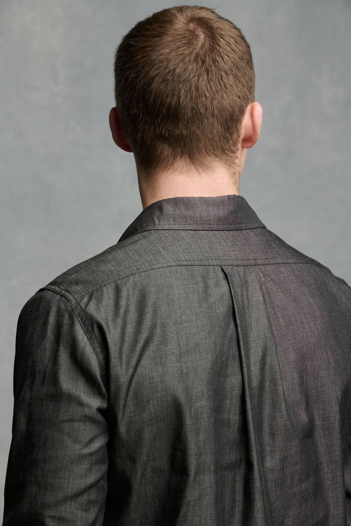 Close up of the back of males' shoulders wearing Oli shirt showing pleat detail 