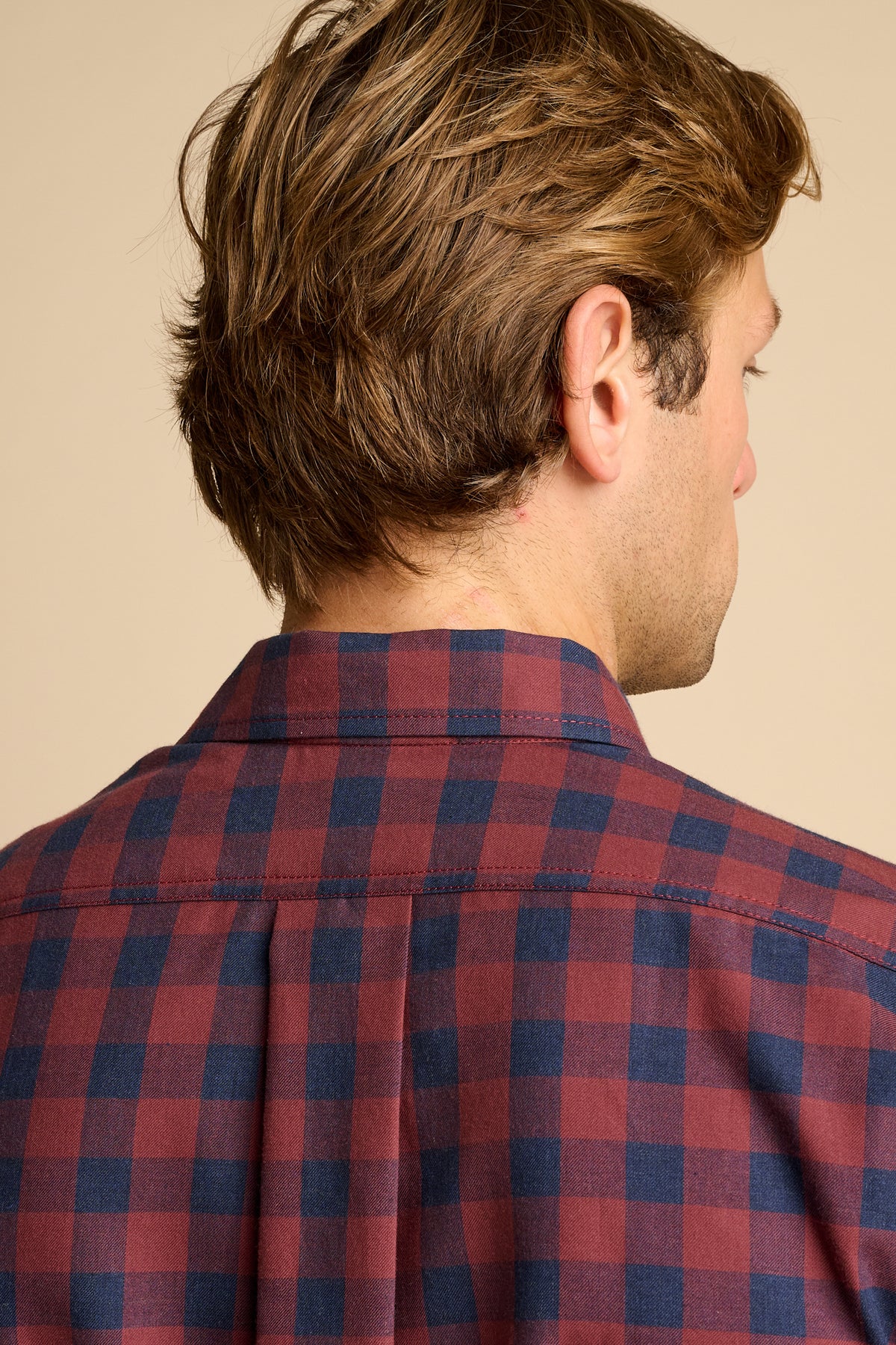 Man wearing red and navy check shirt.
