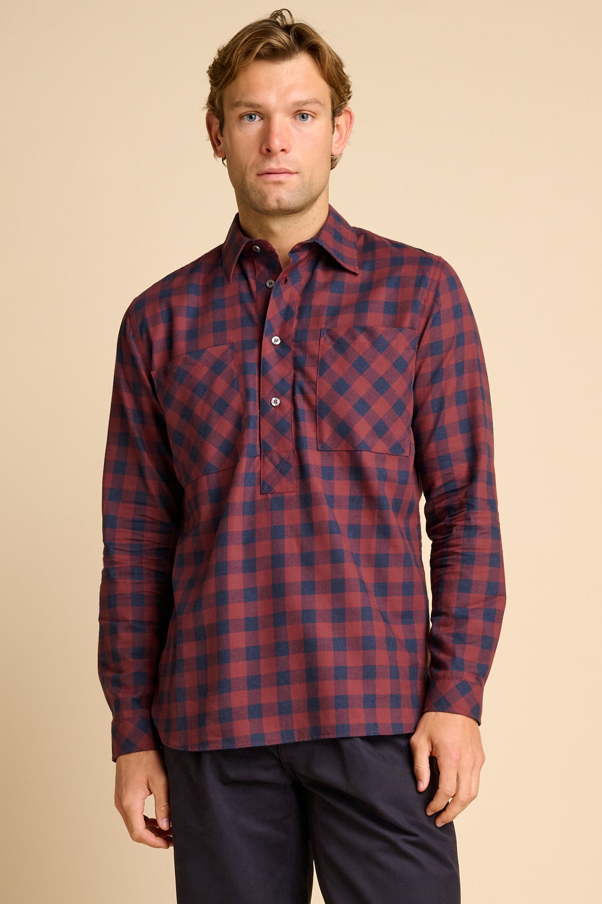 Man wearing red and navy check shirt.