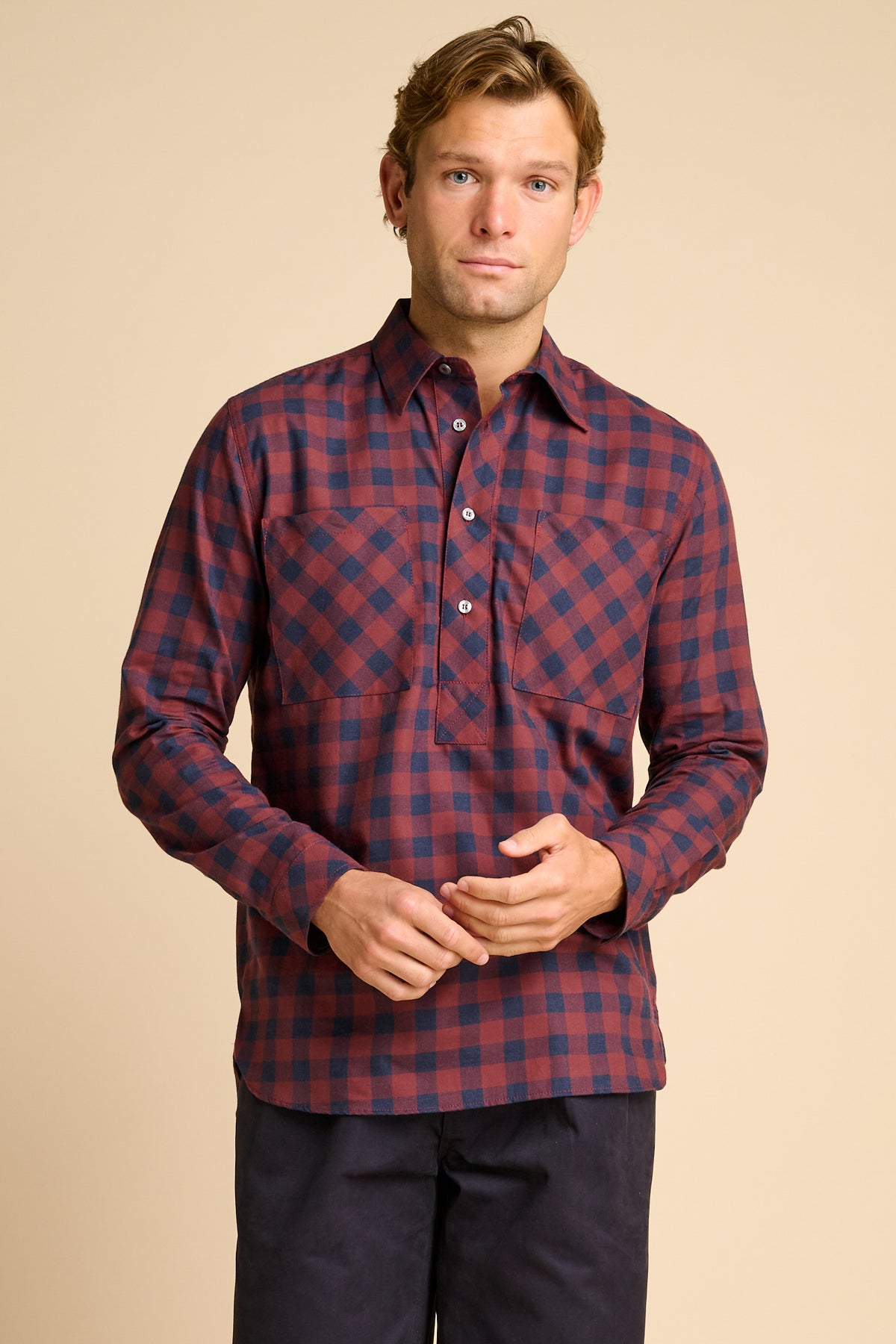 Man wearing red and navy check shirt.