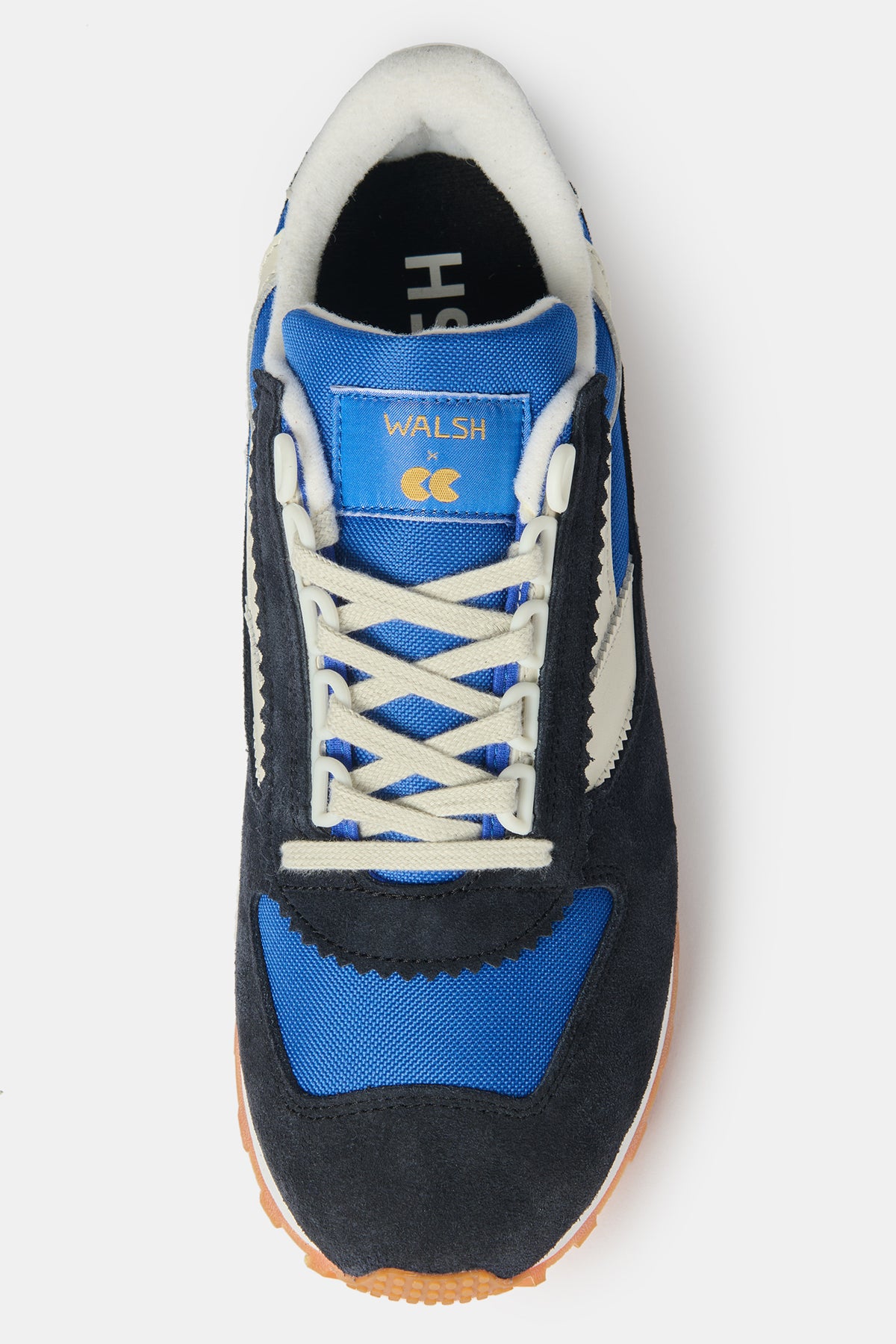 the top of men's Parlick trainer in blue, navy and off white, with WALSH X CC logo on the tongue of shoe