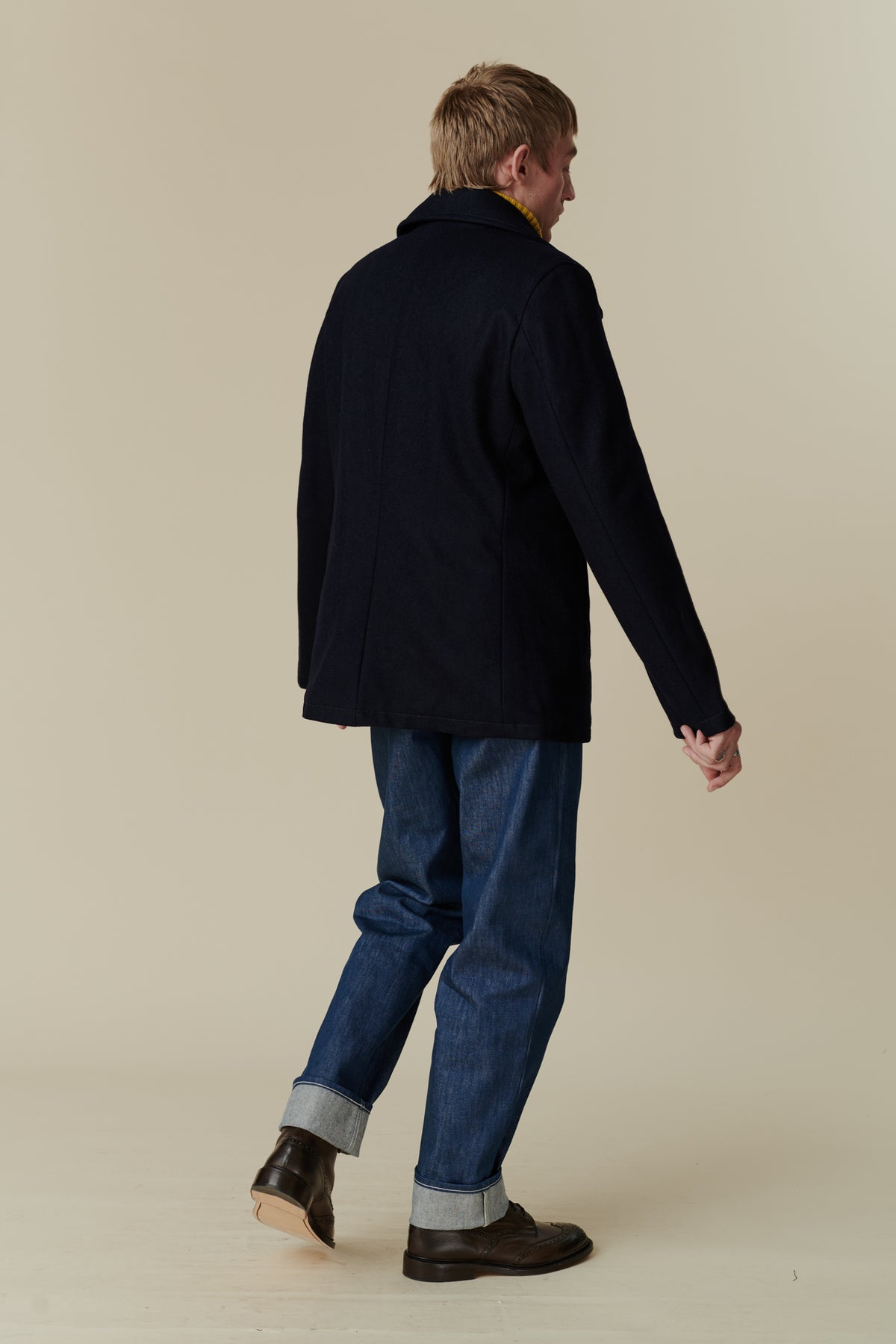 Back of male wearing pea coat in navy 